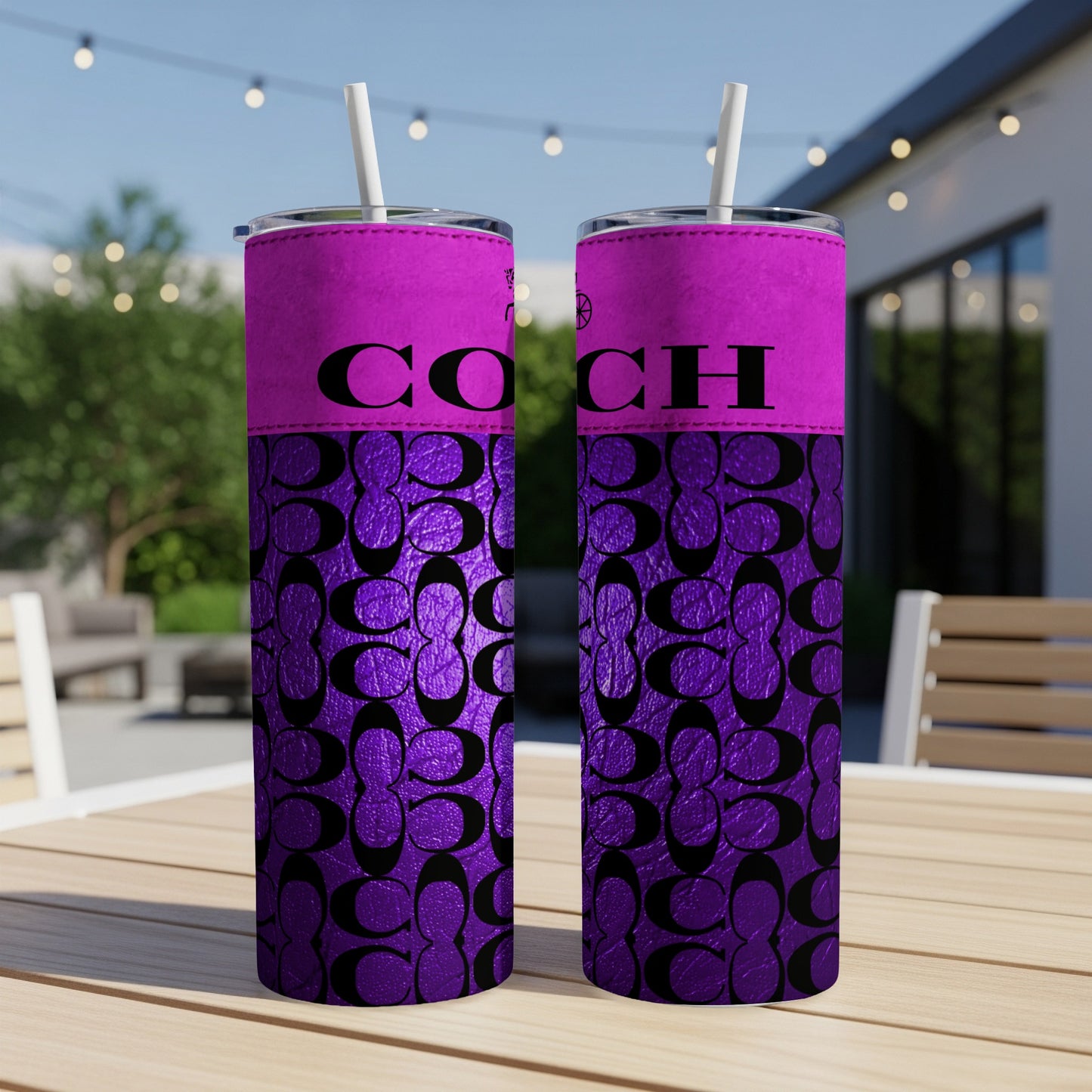 Two purple tumblers with black COACH logo and repeating C pattern.