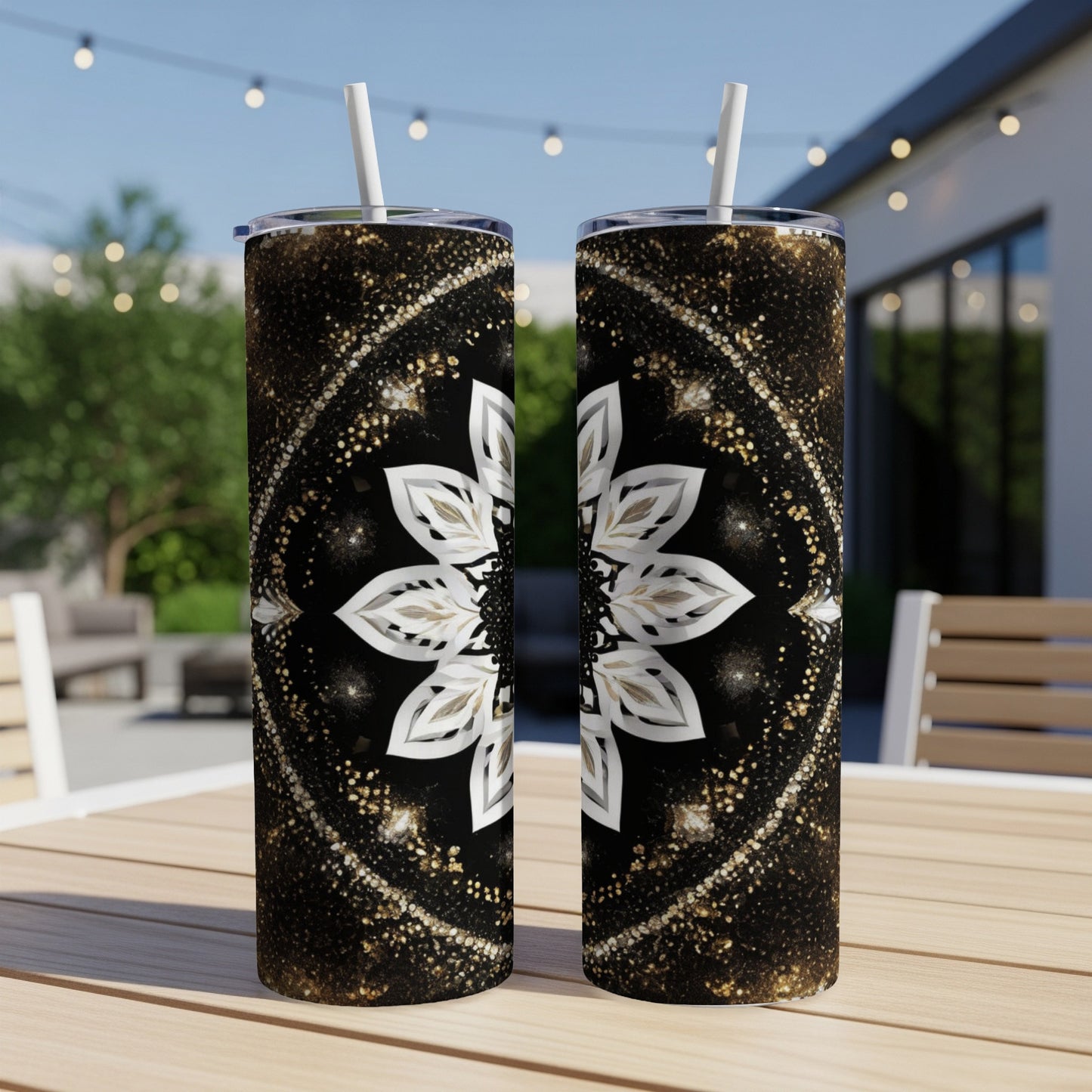Two tall tumblers with mandala patterns on a wooden table.