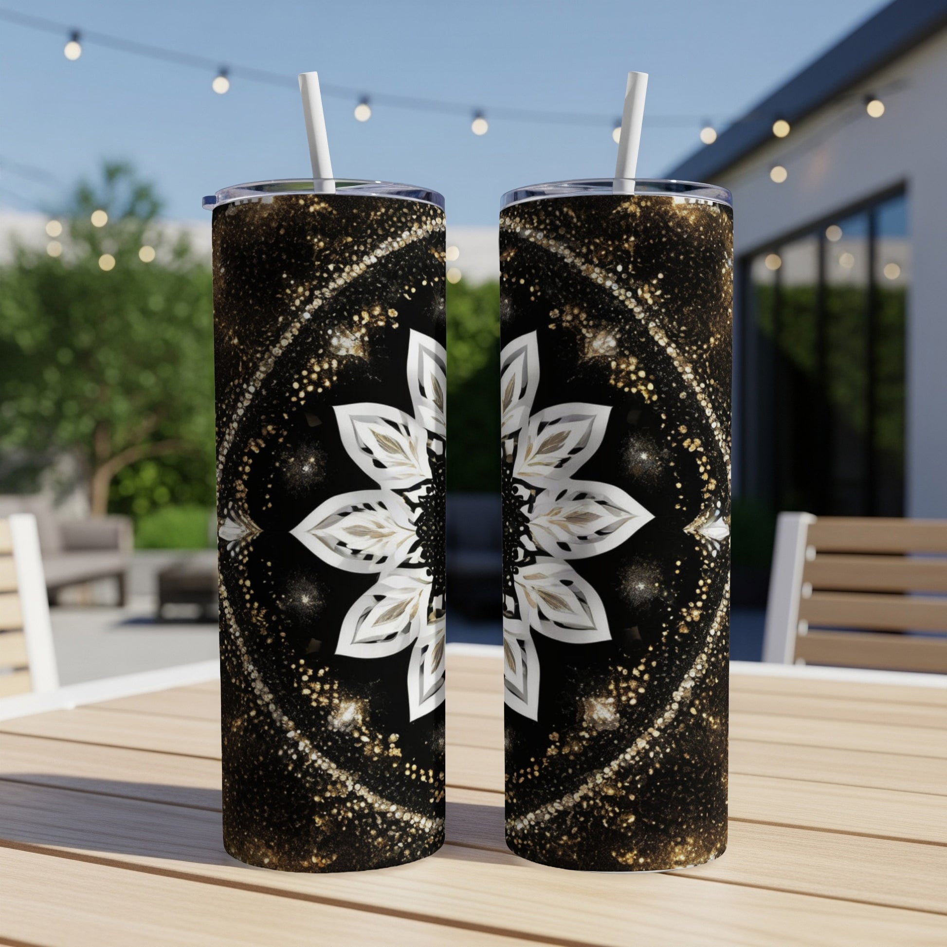 Two tall tumblers with mandala patterns on a wooden table.