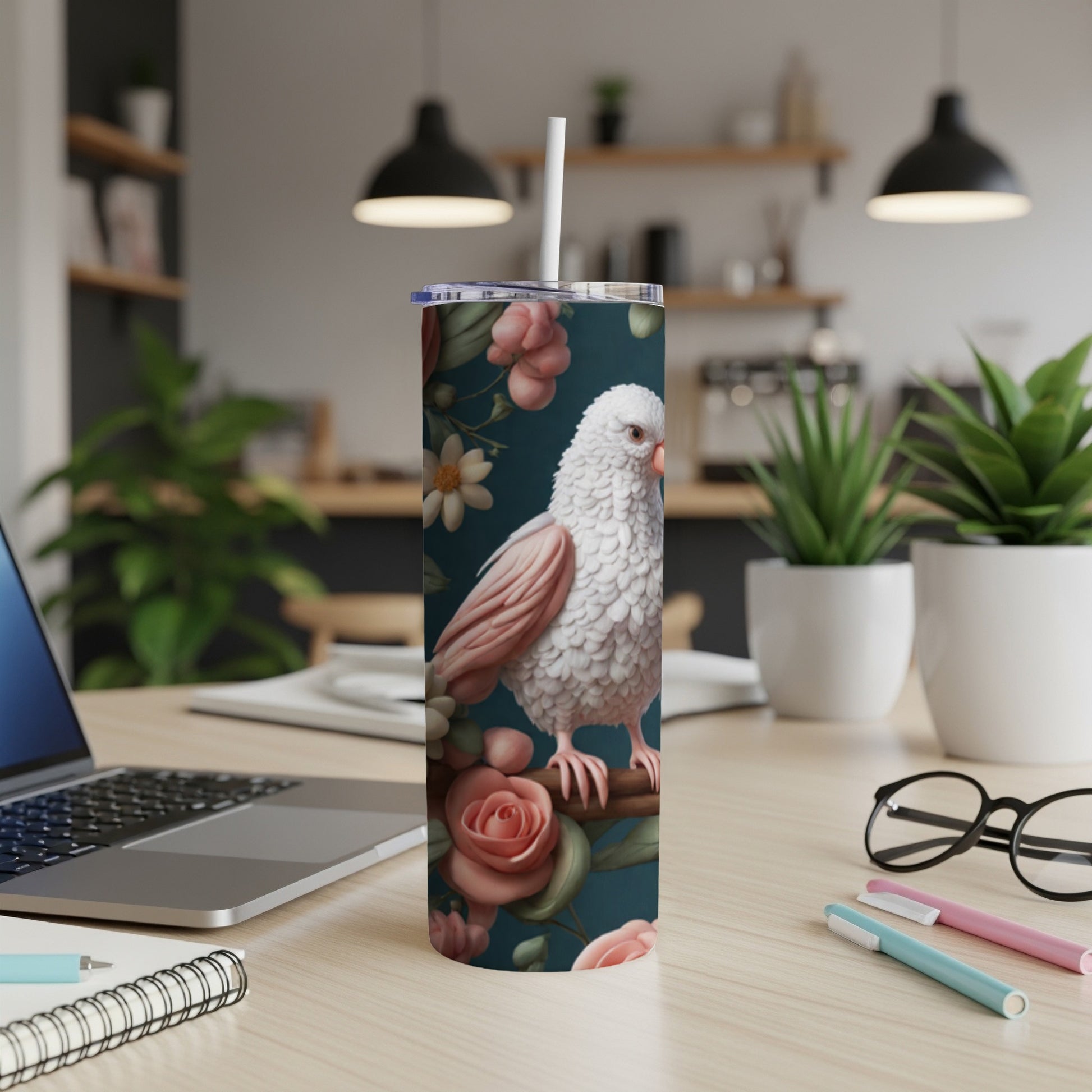 White bird with pink floral pattern on a dark background on a tumbler.