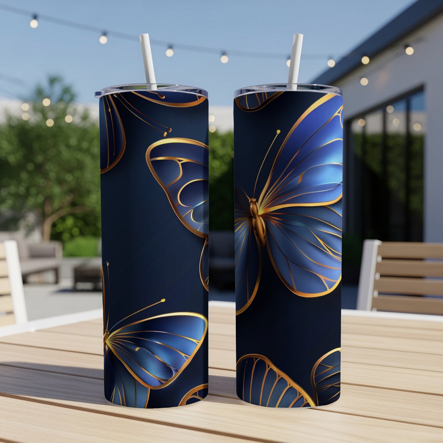 Two tall, navy tumblers with gold-trimmed blue butterfly designs.