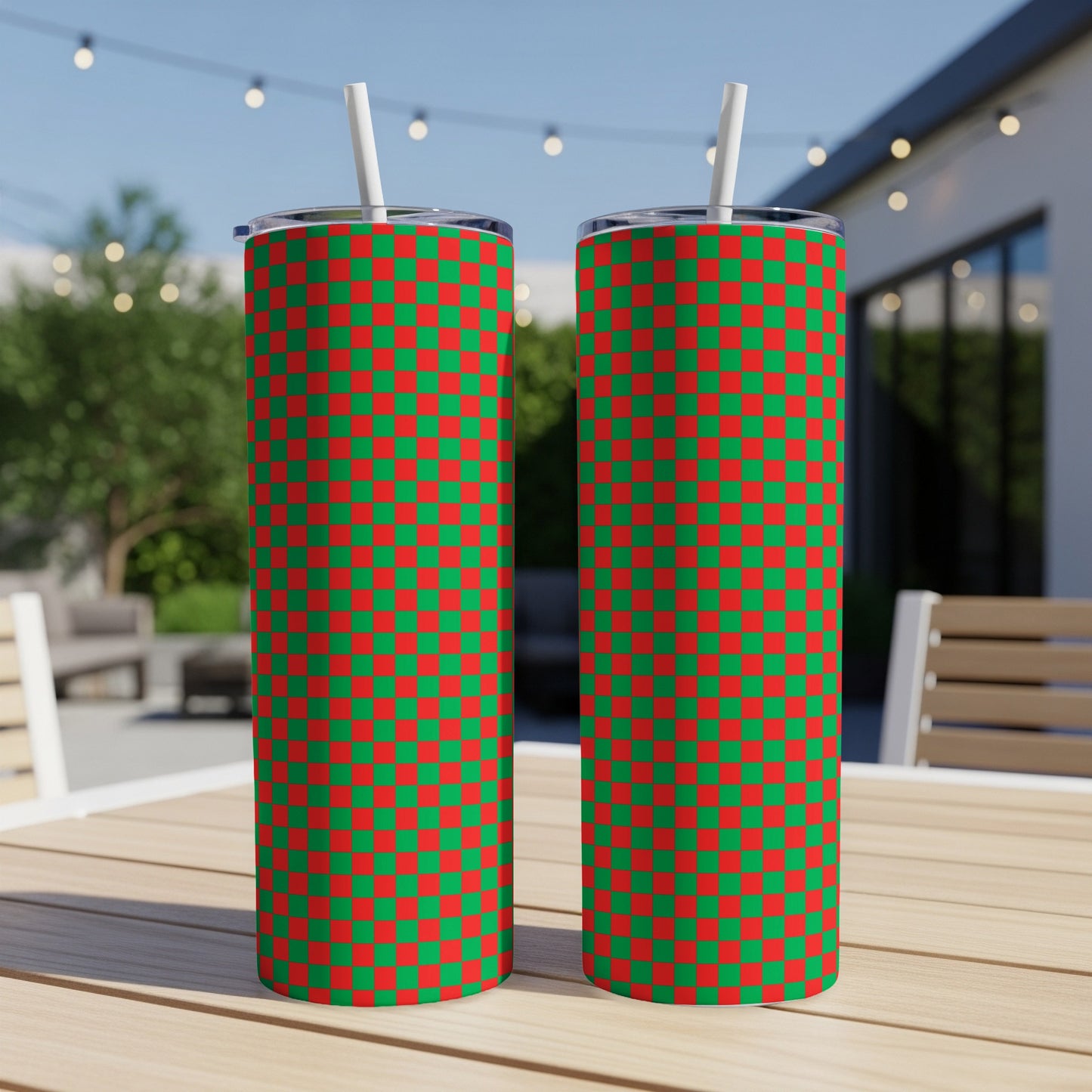 Two tall tumblers with red and green checkerboard pattern, with straws.