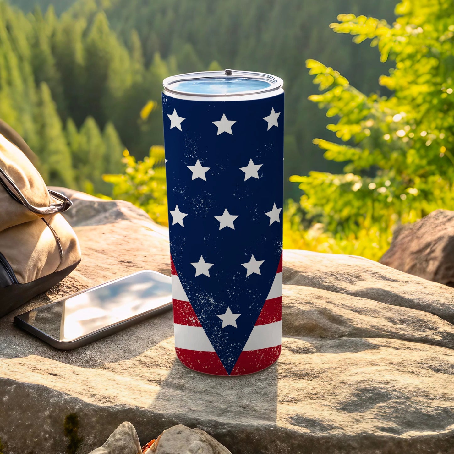 USA flag tumbler with stars and stripes on a rock.
