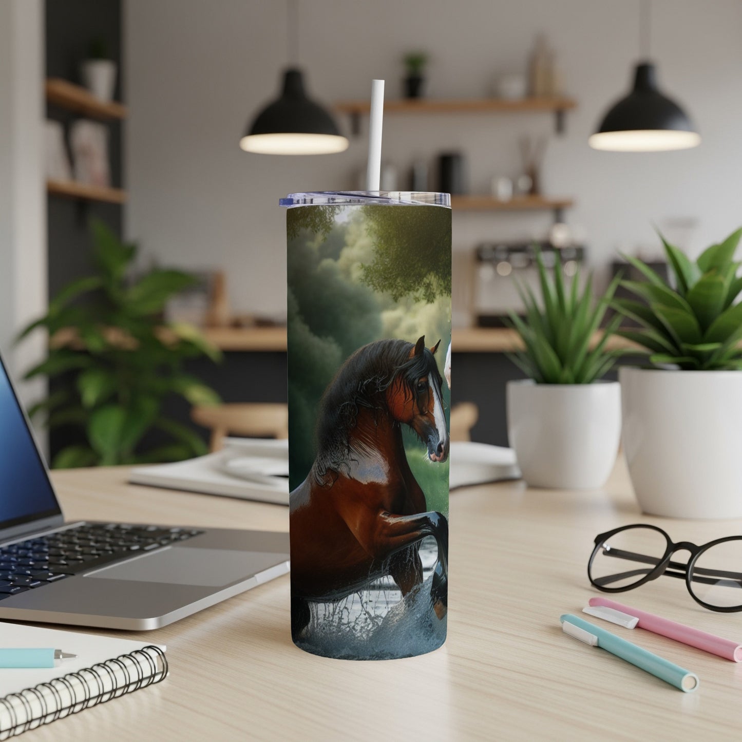Brown horse splashing water, with a laptop and office supplies in foreground.