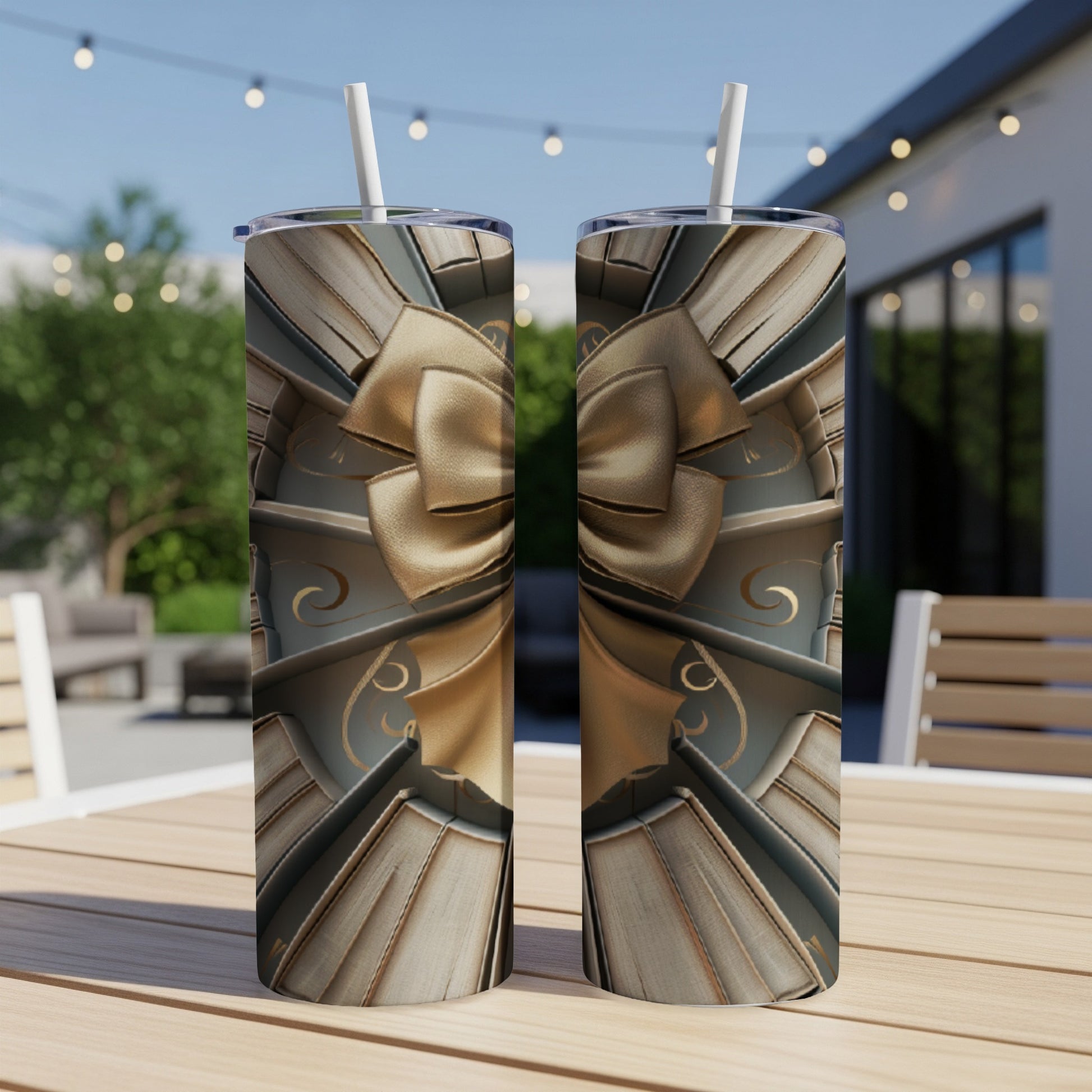 Two tall tumblers with a gold ribbon and bow design on a wooden table.