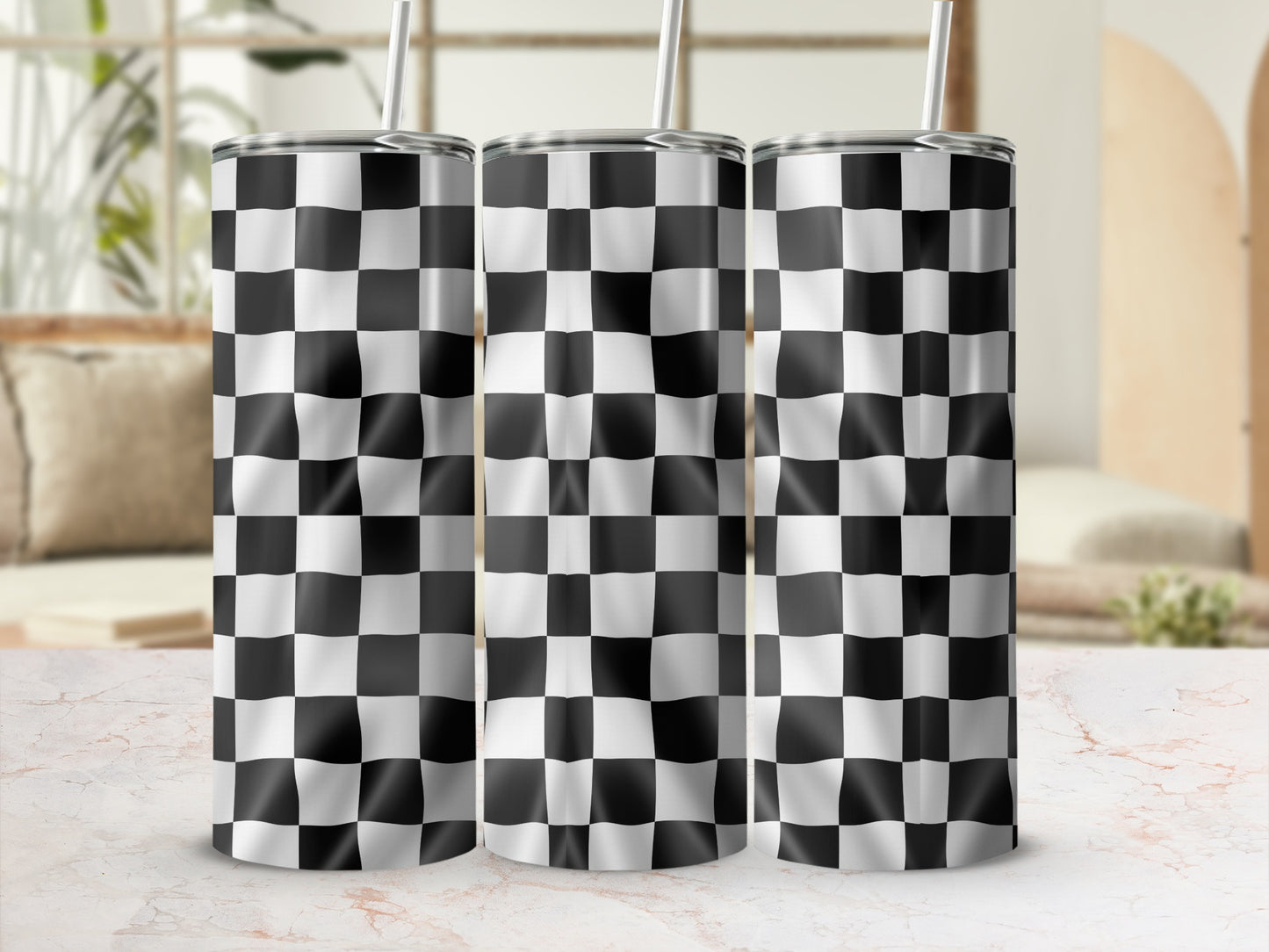 Three tumblers with black and white checkered pattern, standing on a marbled surface.