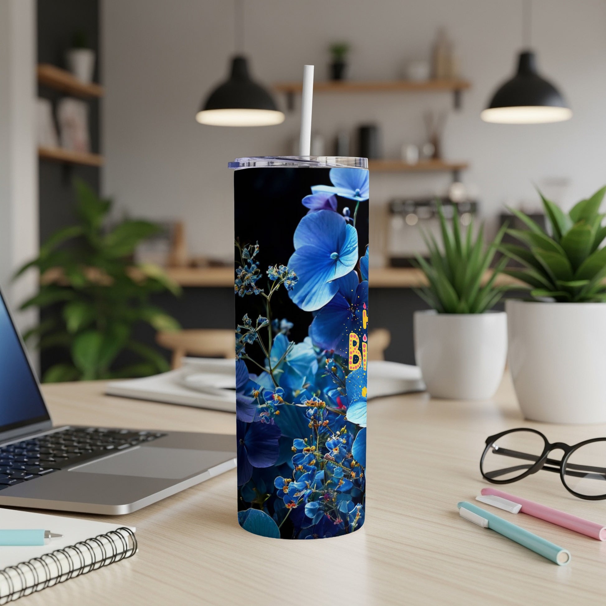 Blue floral pattern on a dark background wraps a stainless steel tumbler.