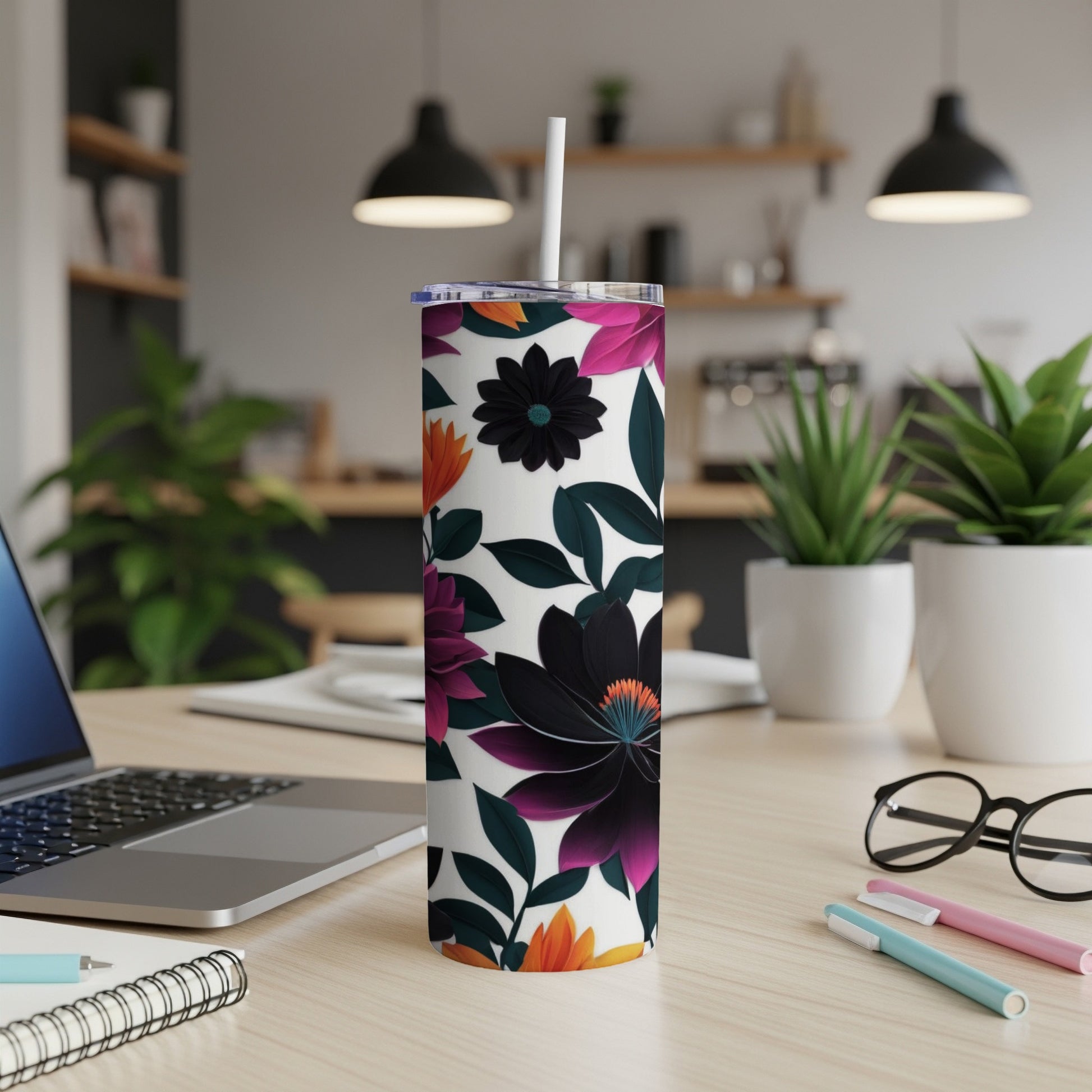 White tumbler with dark floral pattern, straw, and office desk background.