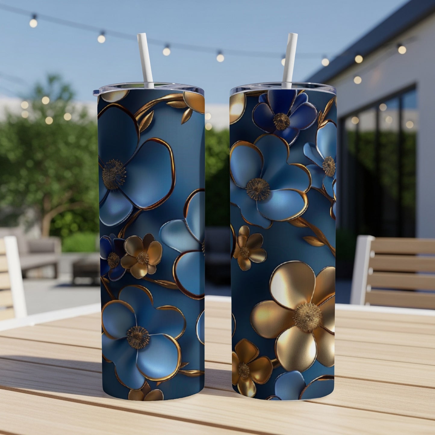 Two blue tumblers with floral patterns sit on a table.