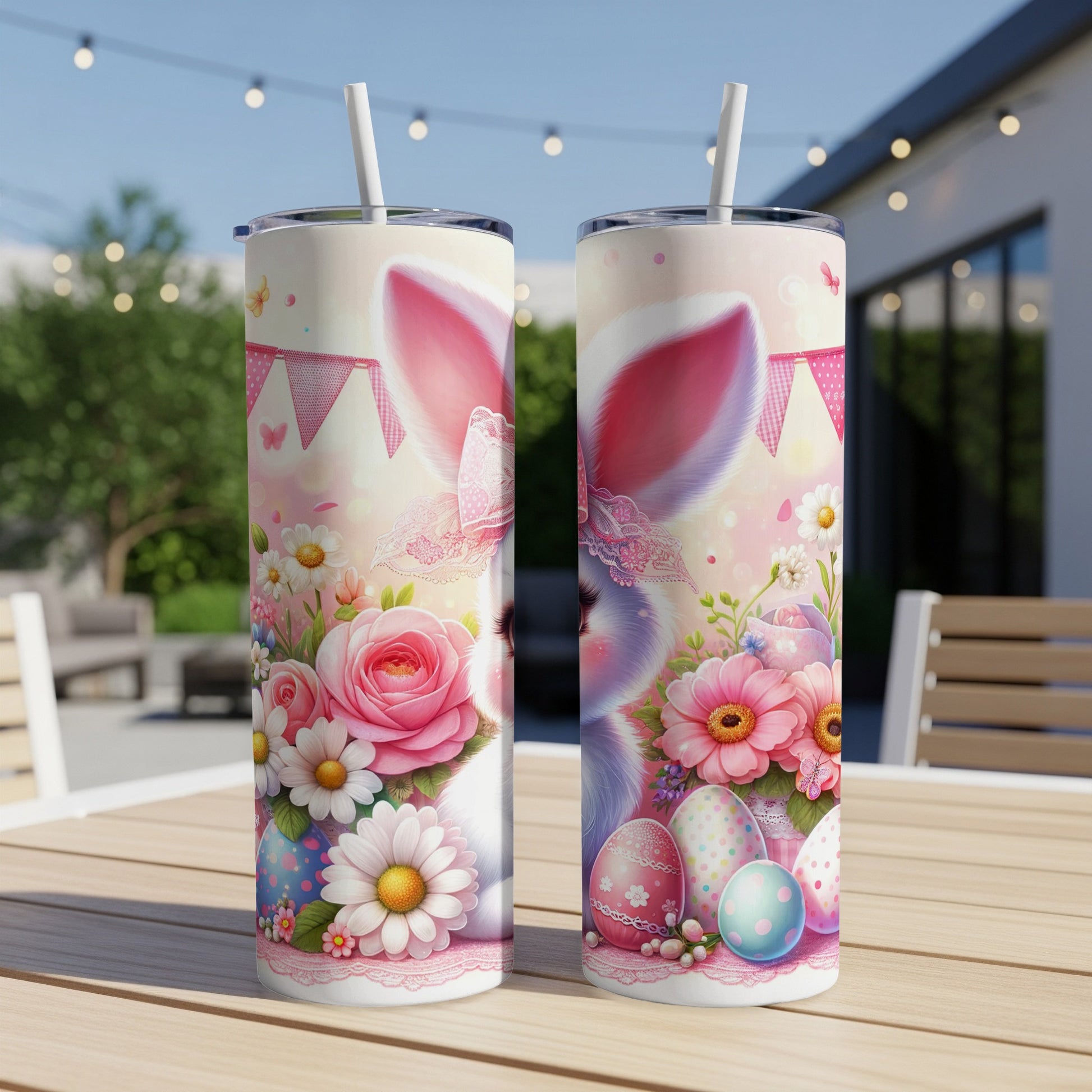 Two Easter-themed tumblers with bunnies and floral designs on a patio table.