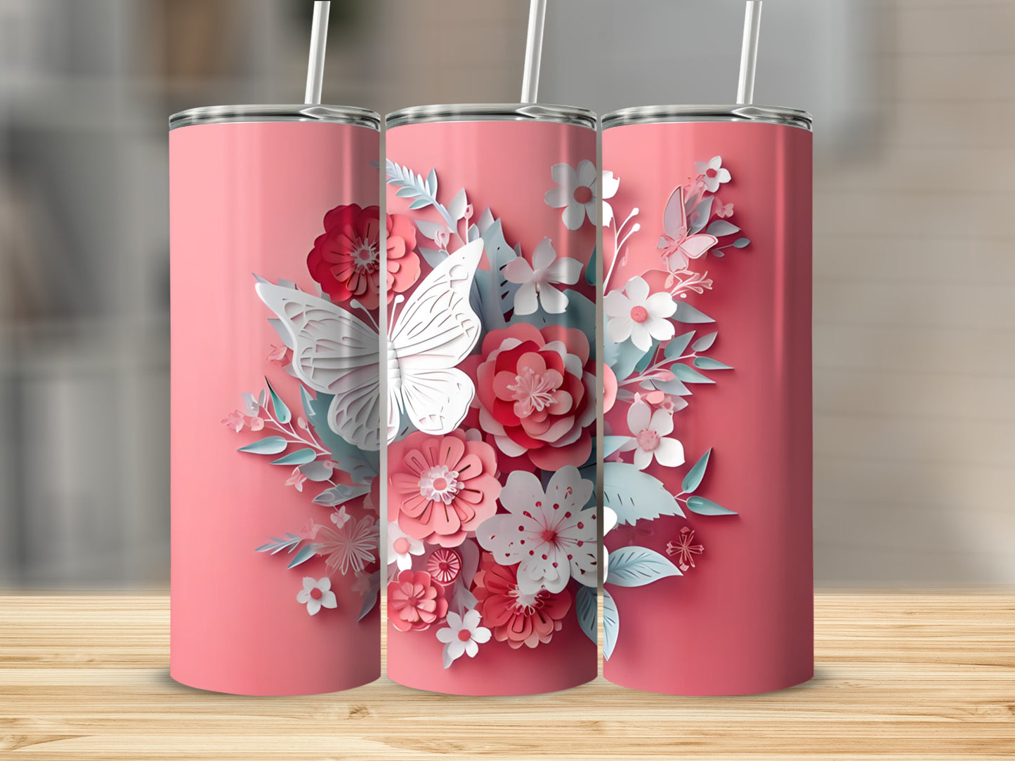 Three pink tumblers with floral and butterfly designs.