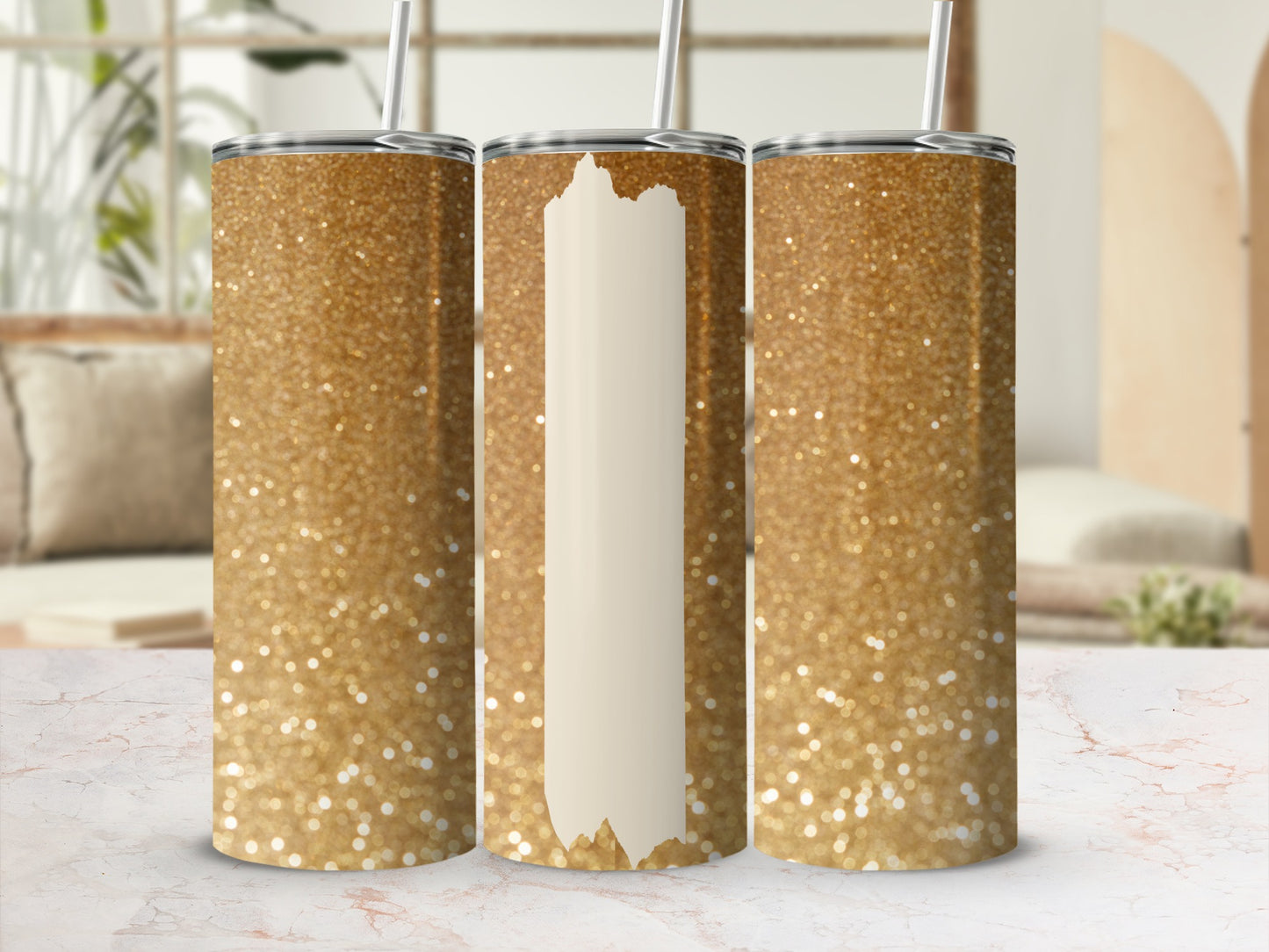 Three glittery gold tumblers with straws, two showing full sparkle.