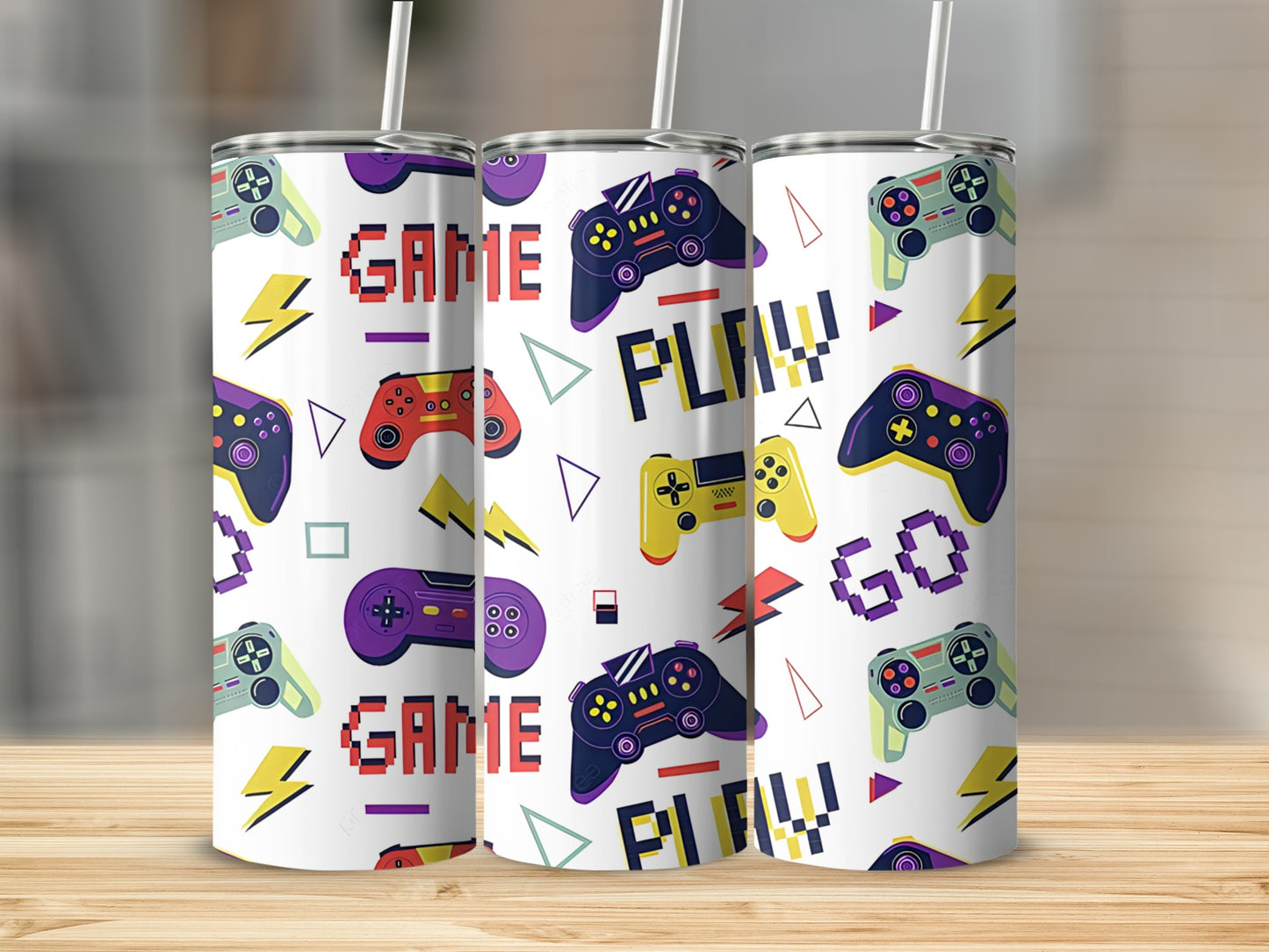 Three tumblers with a repeating pattern of video game controllers and the words "GAME" and "PLAY".