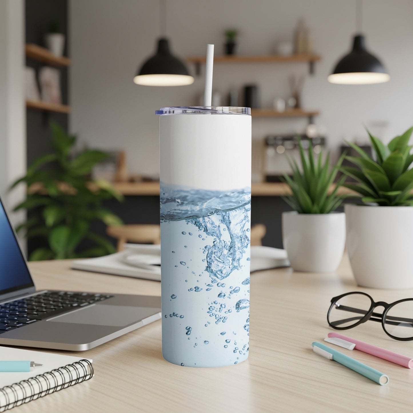 White tumbler with splashing water pattern on wooden desk.