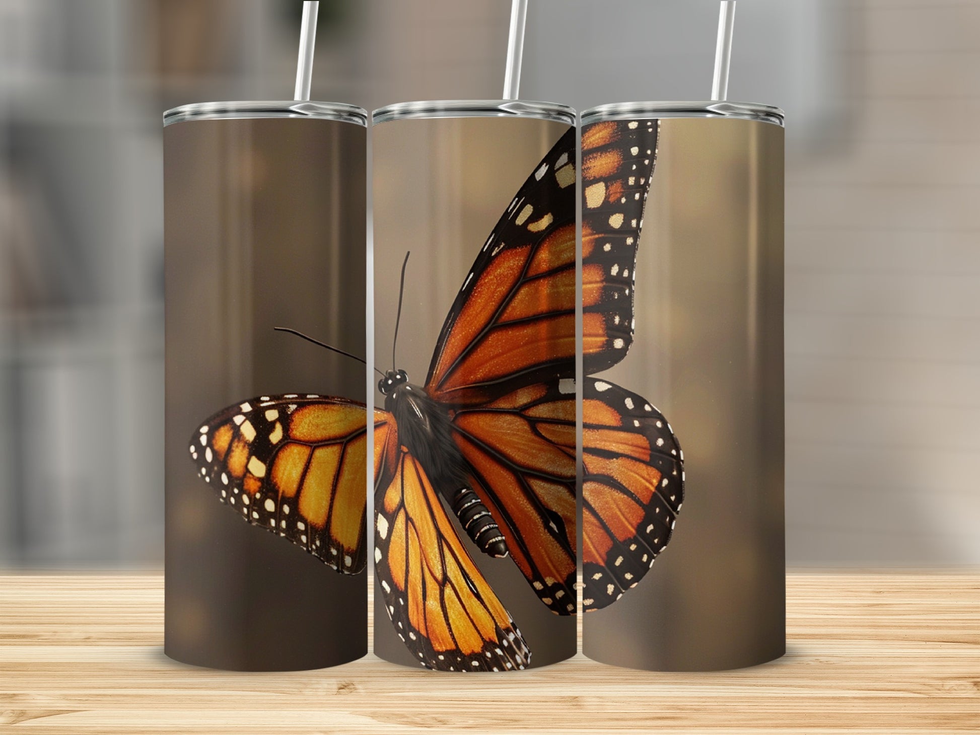 Monarch butterfly on a brown background, shown on three tumblers.