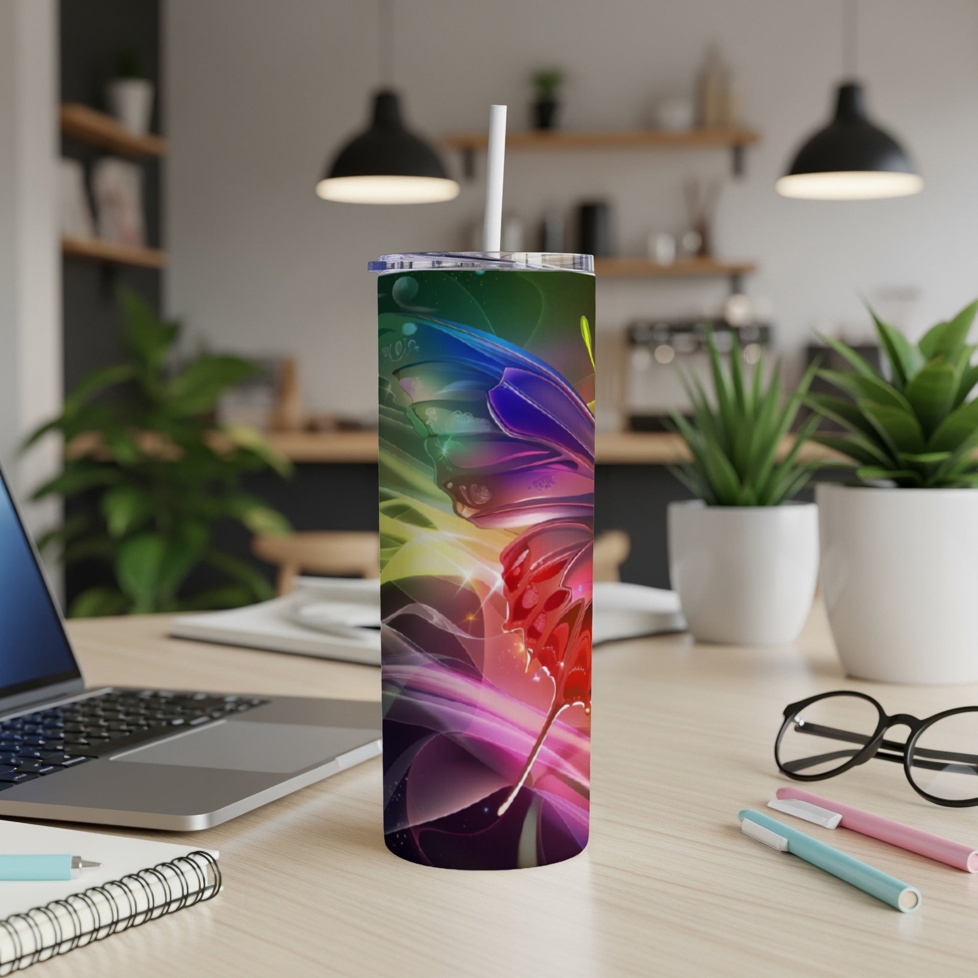 Tumbler with colorful abstract butterfly design and white straw.