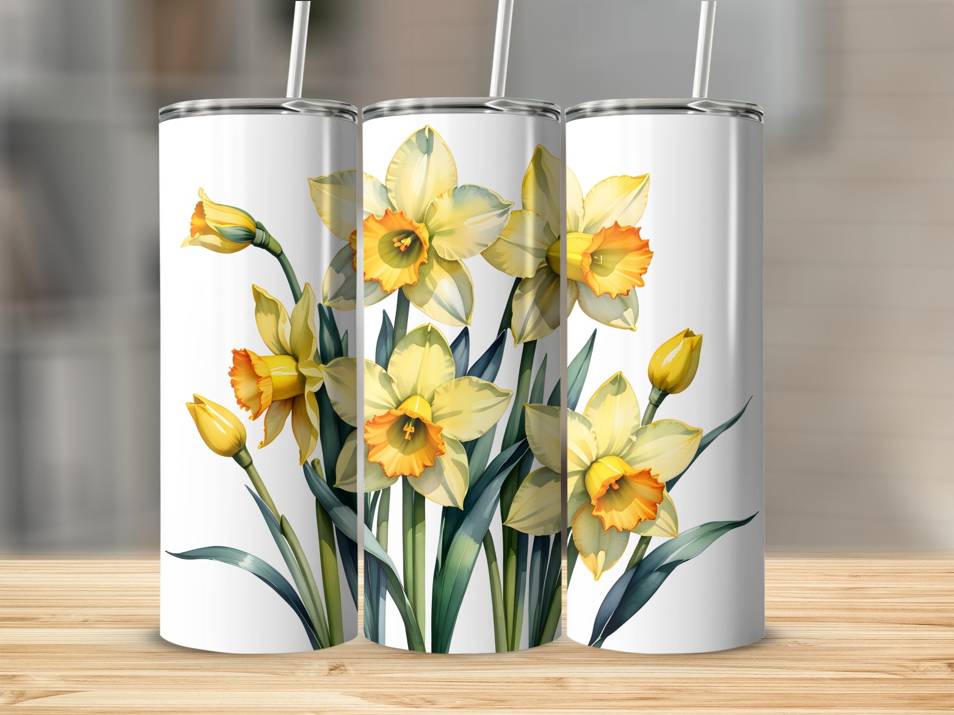 Three tumblers with yellow daffodils and green stems.