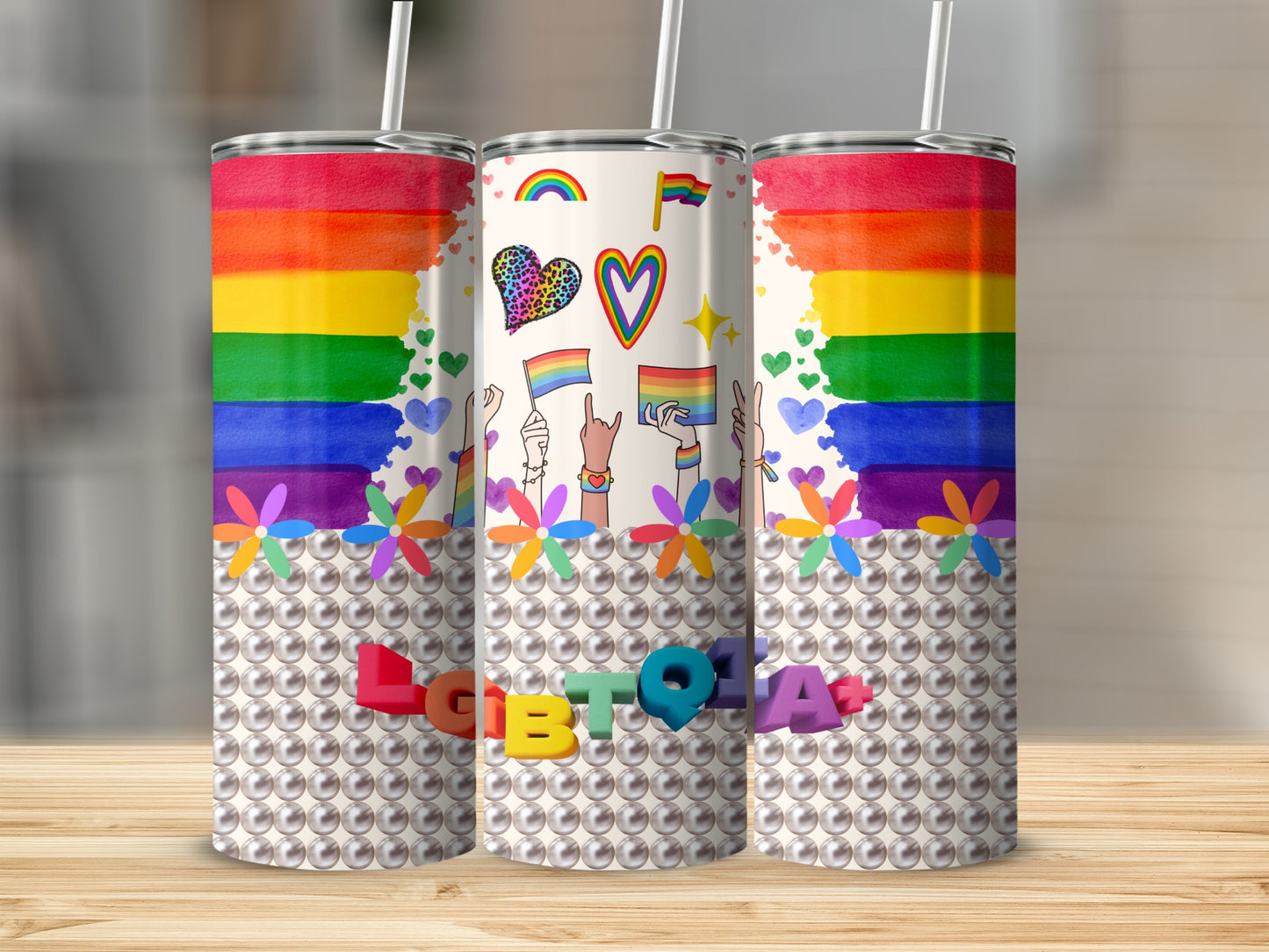 Rainbow pride tumbler with "LGBTQIA" in pearl lettering.