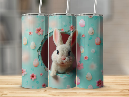 Easter bunny peeking from round opening on turquoise tumbler with pink flowers and eggs.