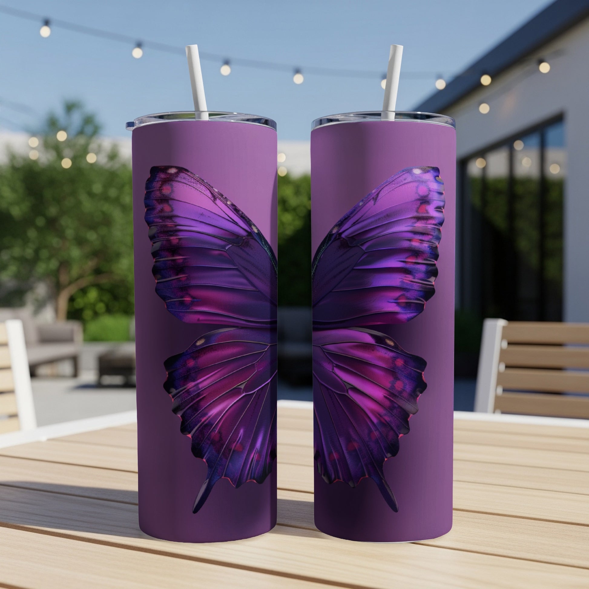 Purple butterfly wings design on two slim tumblers with straws.