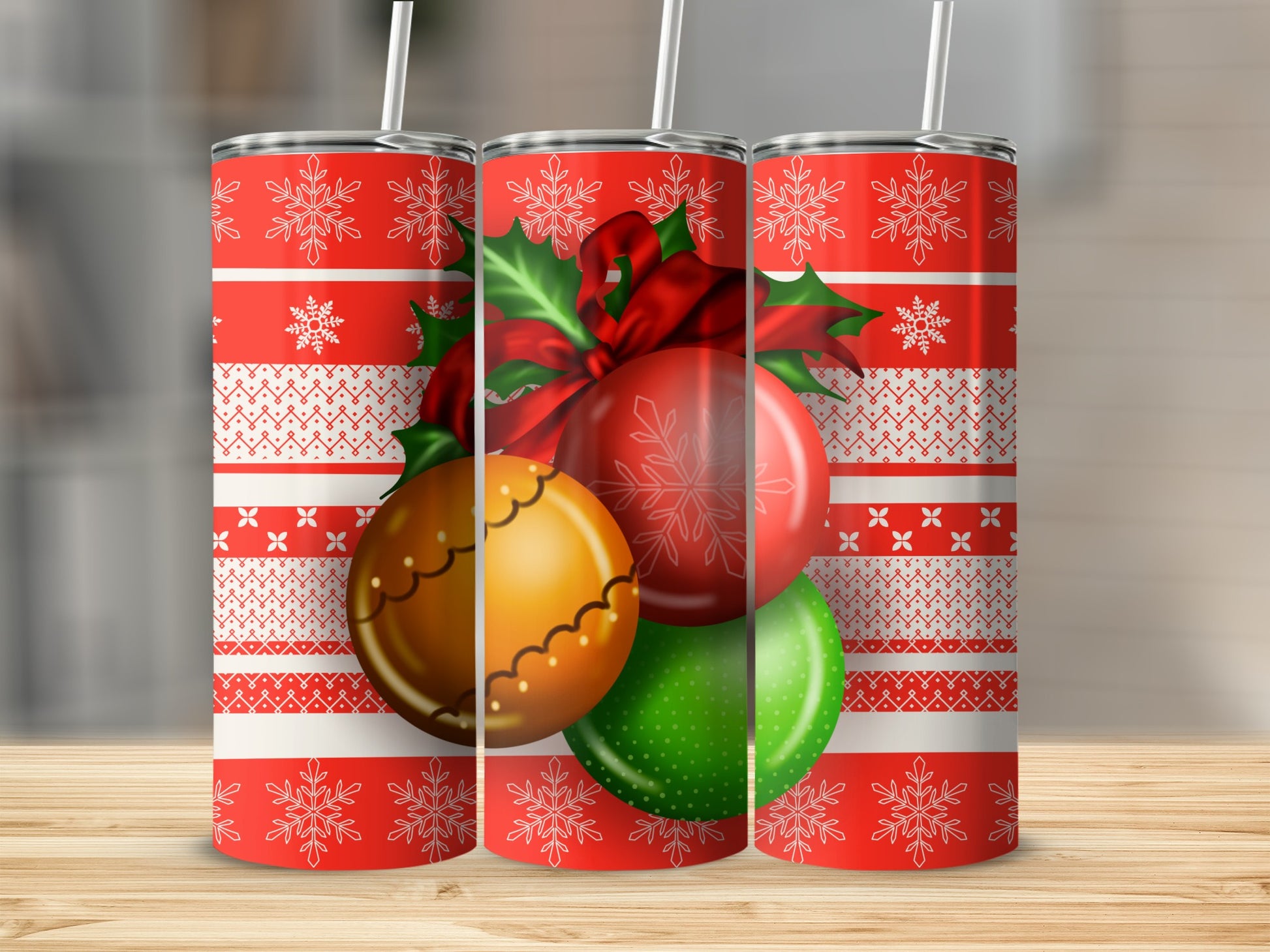 Three Christmas-themed tumblers with snowflakes and ornaments.