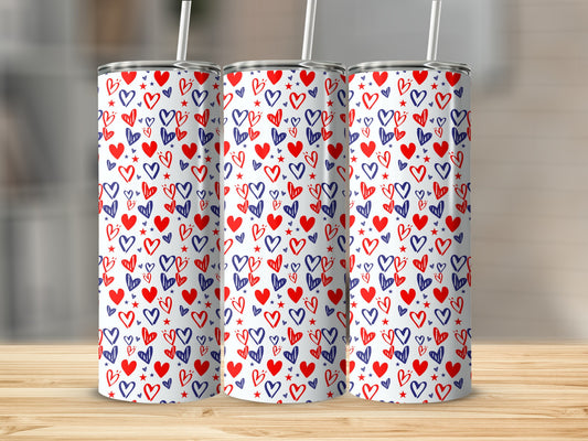 Three tall tumblers with a red and blue heart pattern on a wooden surface.