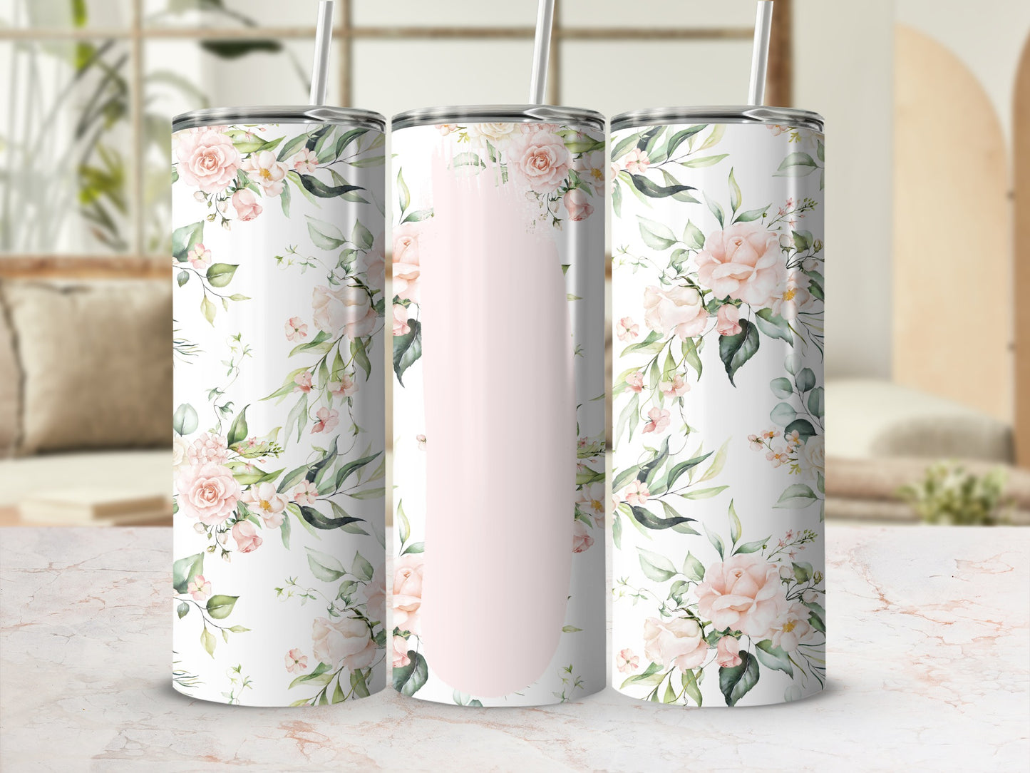 Pink floral design on three tumblers with straws.