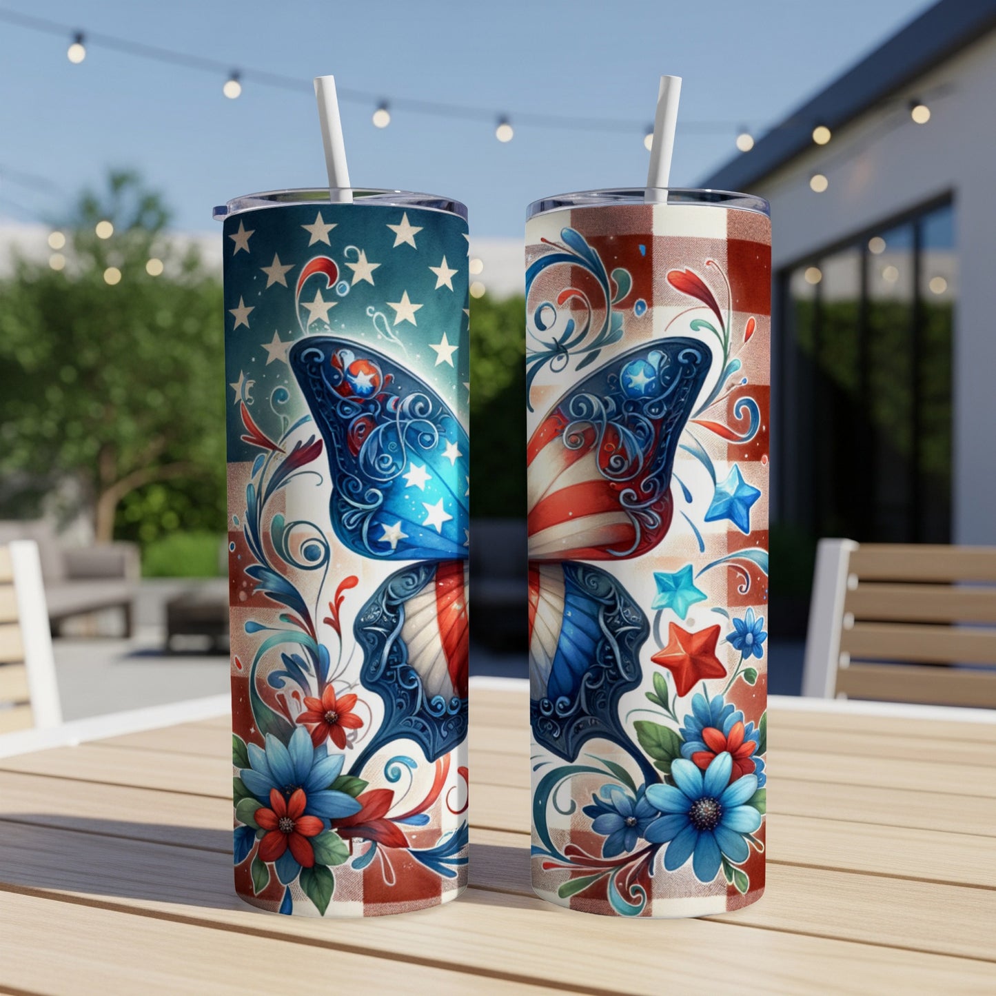 Two patriotic tumblers with butterfly and floral designs on a table.