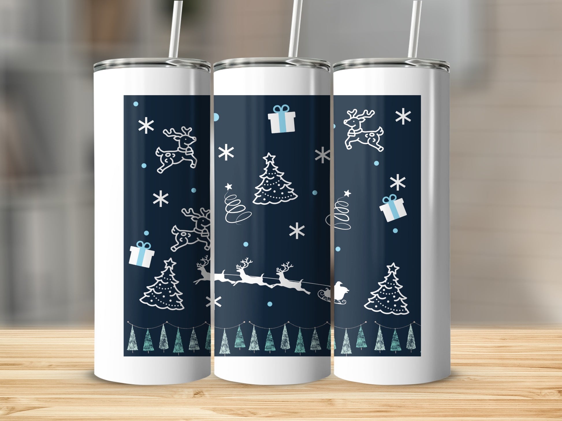 White tumblers with blue Christmas pattern featuring trees and reindeer.