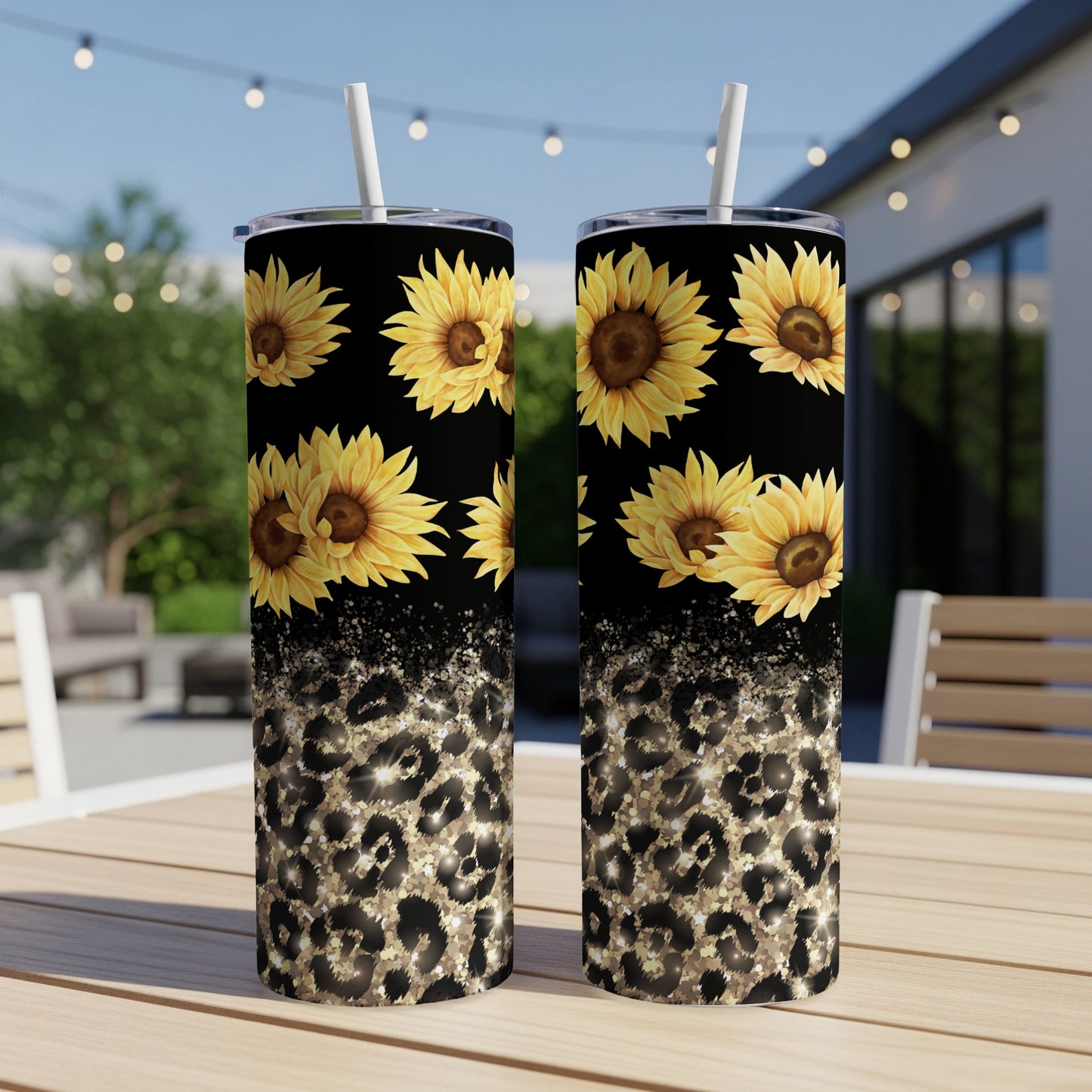 Two tumblers with sunflowers and leopard print patterns on a table.
