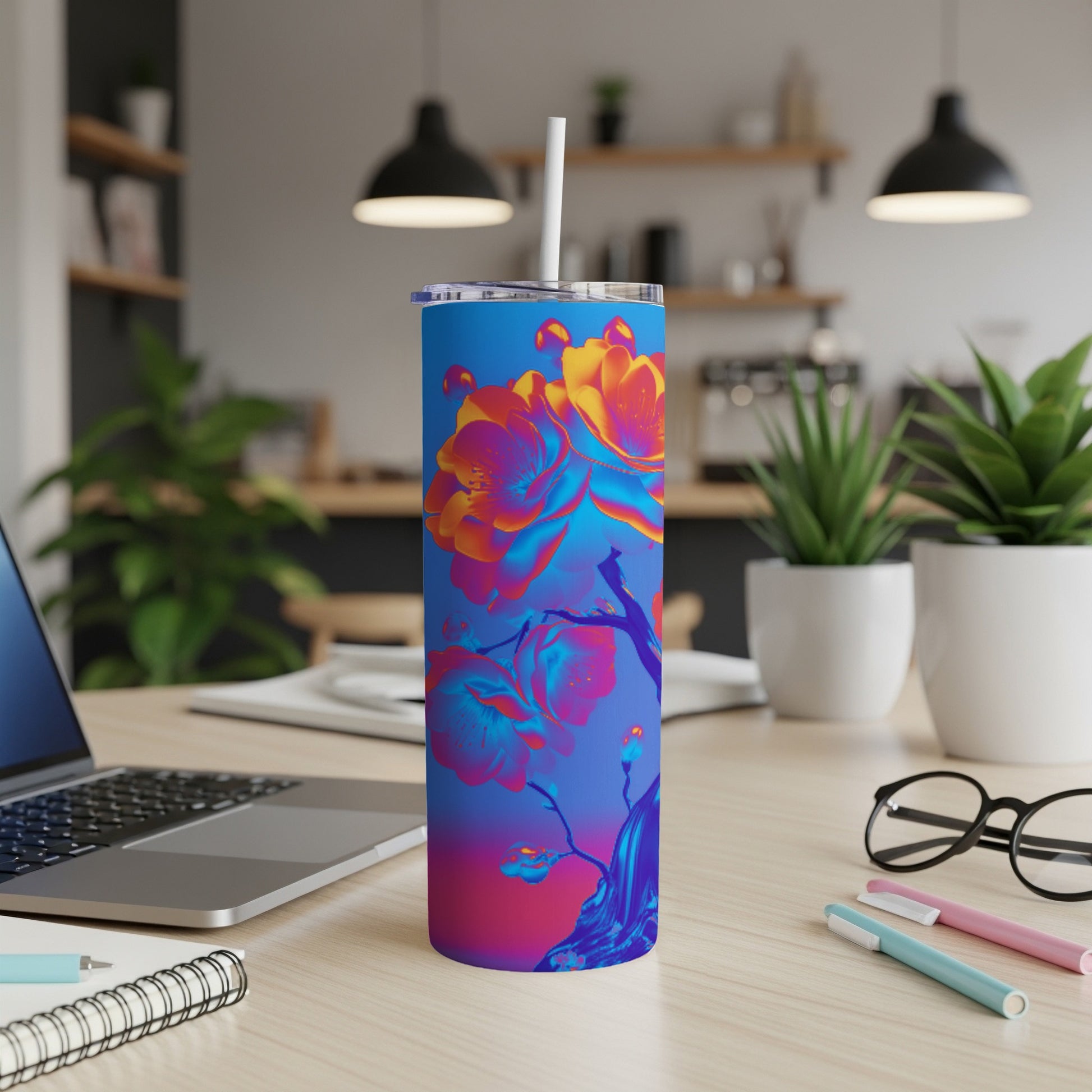 Blue gradient tumbler with a vibrant floral design and a white straw.