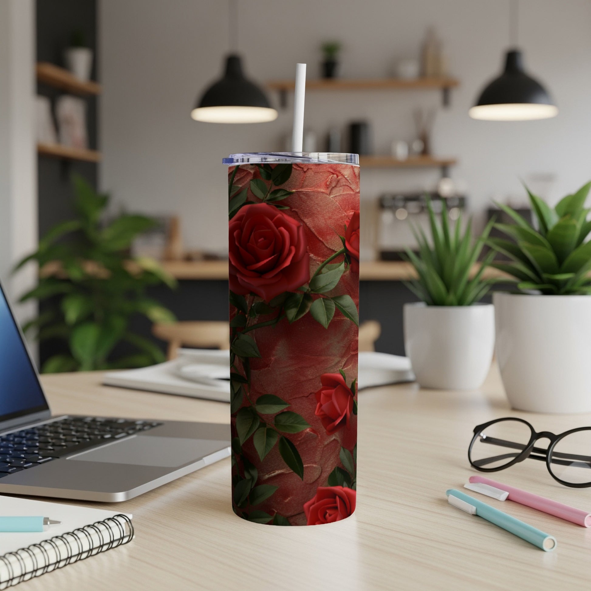 Red roses on a textured red tumbler with a white straw.