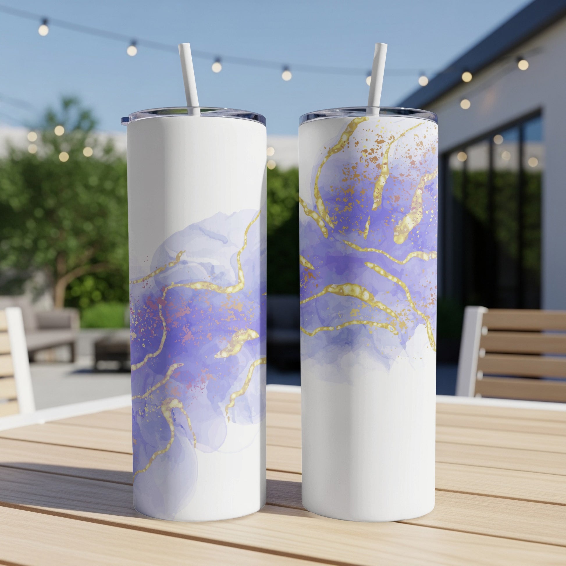 Two tall white tumblers with purple and gold marble design.