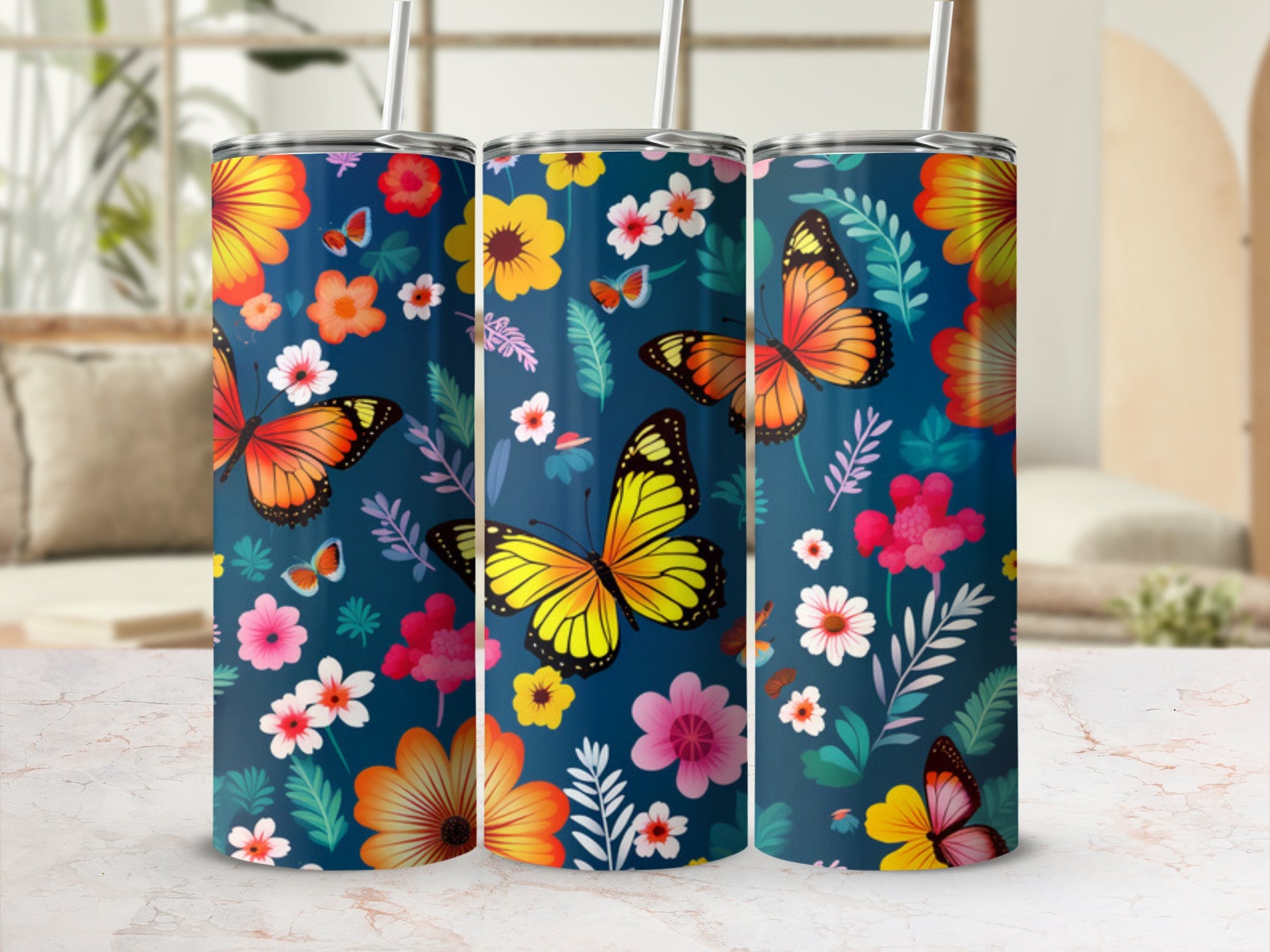 Three tumblers with a navy background, featuring orange and yellow butterflies and colorful floral patterns.