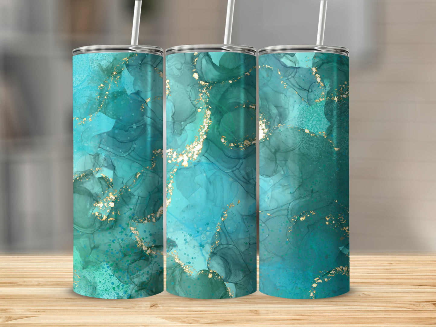 Three tumblers with abstract teal, blue, and gold marbling design.