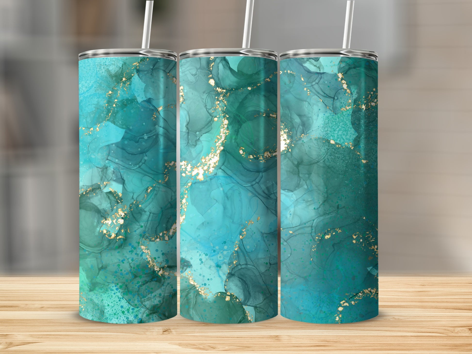 Three tumblers with abstract teal, blue, and gold marbling design.