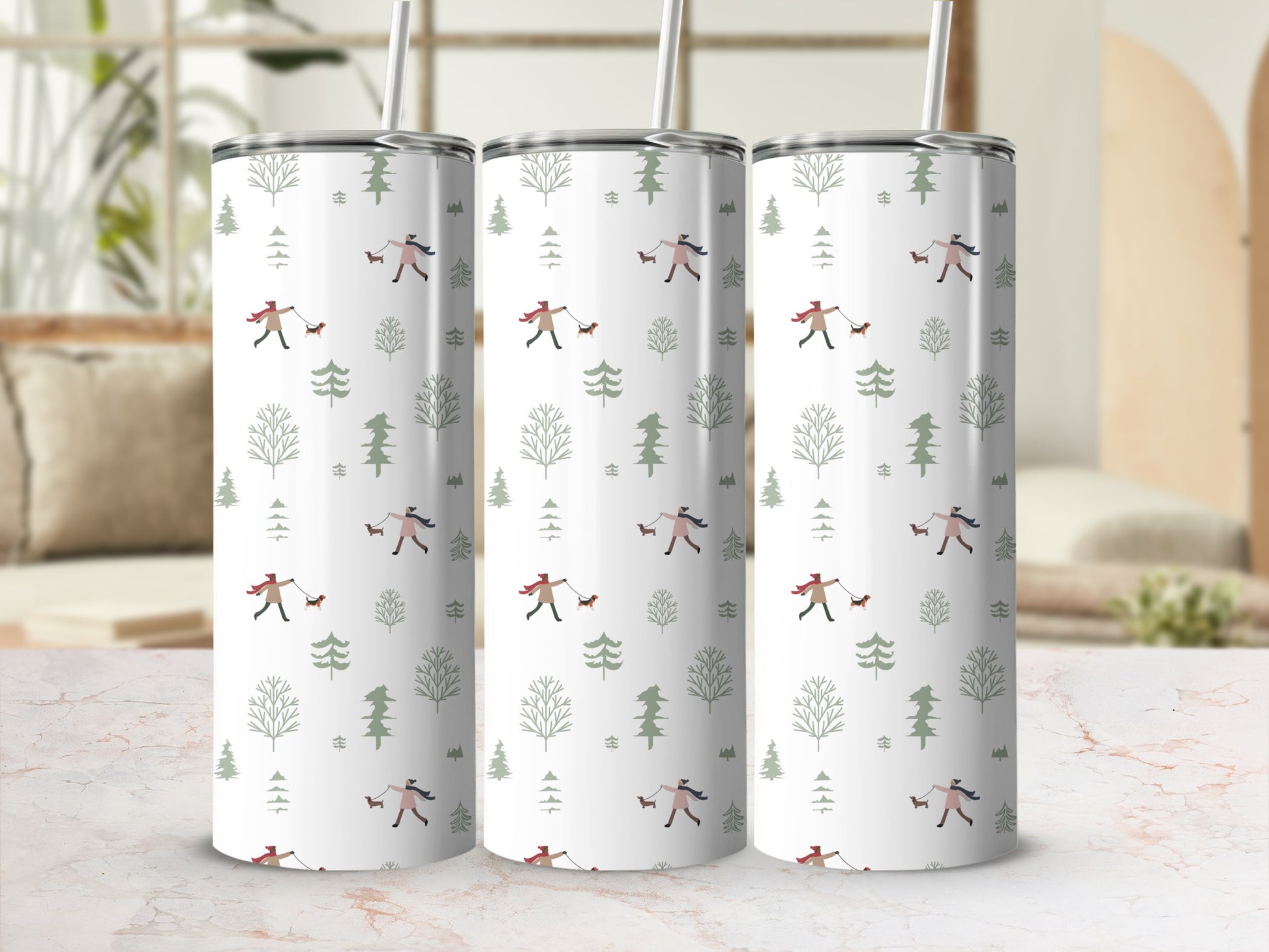 Three insulated tumblers with a white background and forest-themed pattern.