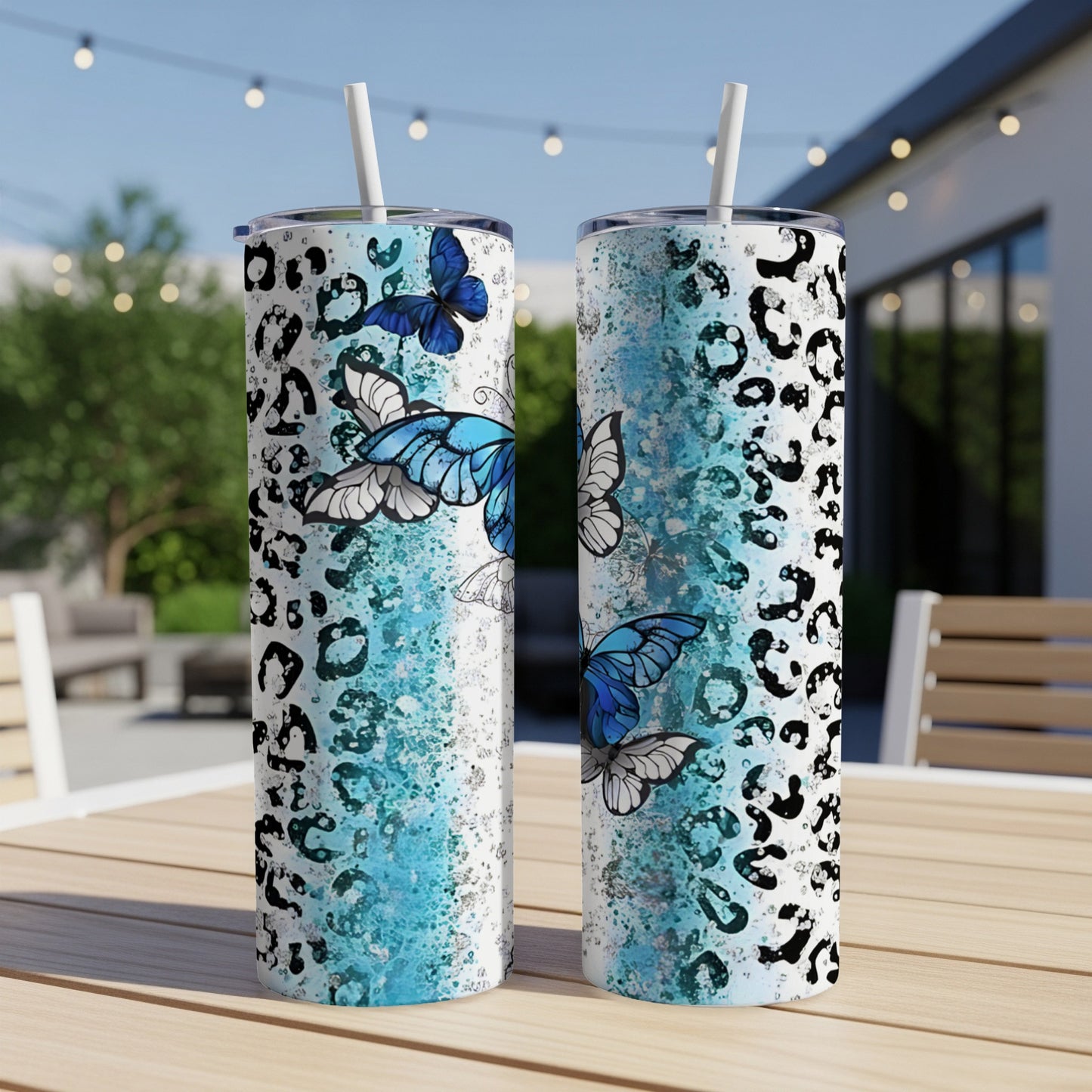 Two tall tumblers with blue butterflies and black leopard print.