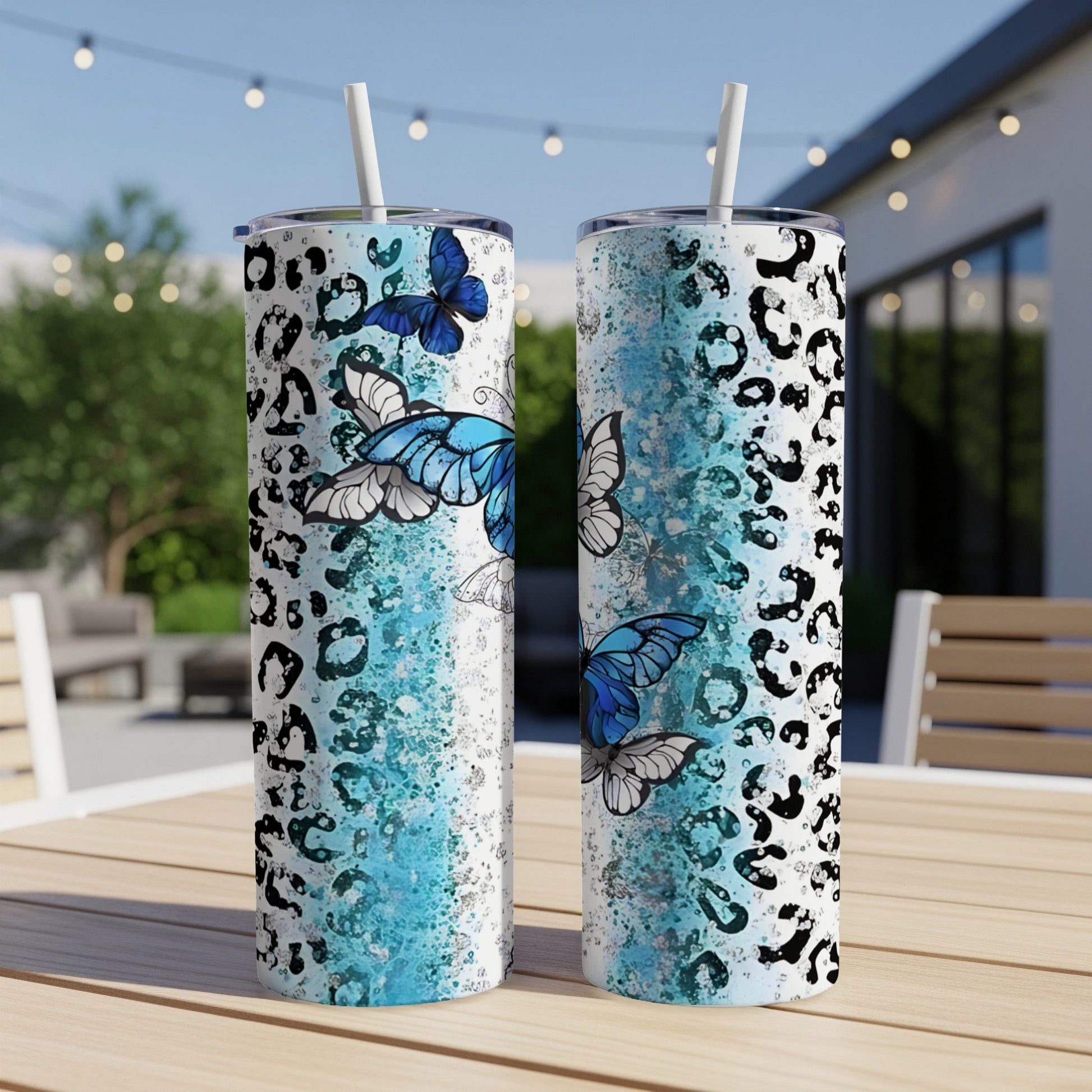Two tall tumblers with blue butterflies and black leopard print.