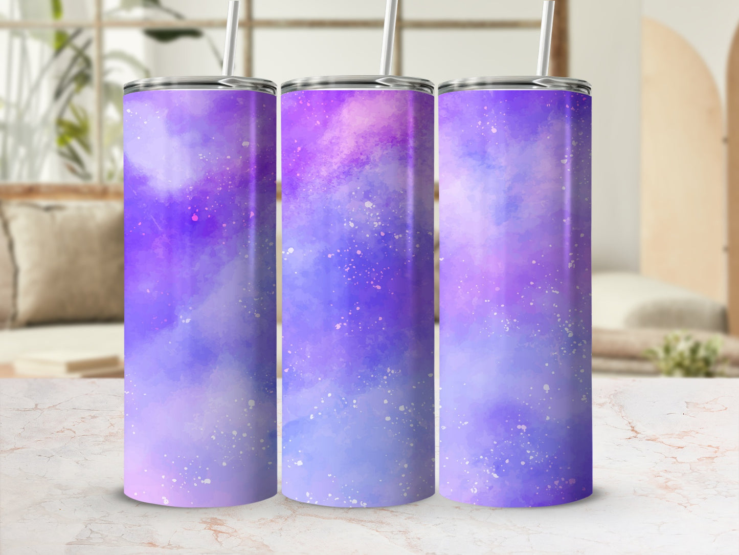 Three tumblers with a purple and blue watercolor galaxy design and white specks.