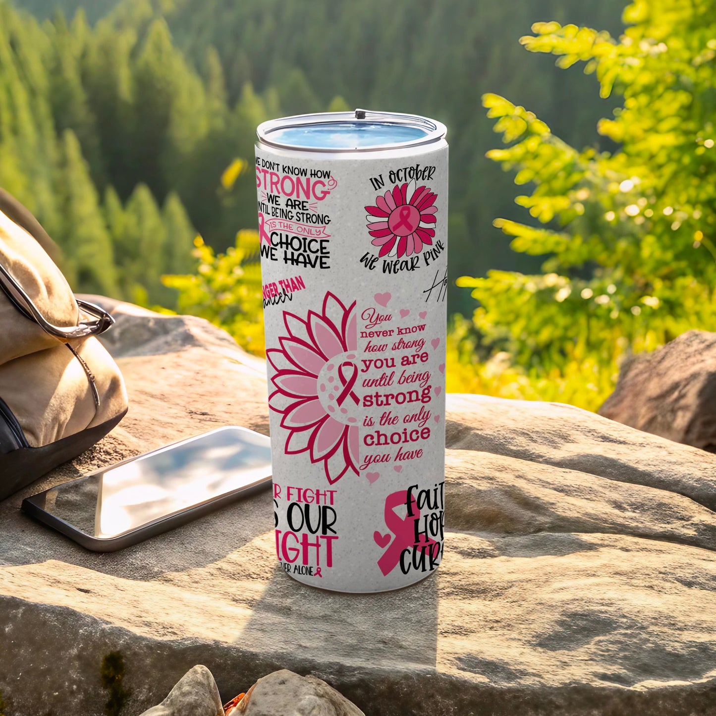 Pink ribbon tumbler with motivational text and floral accents.