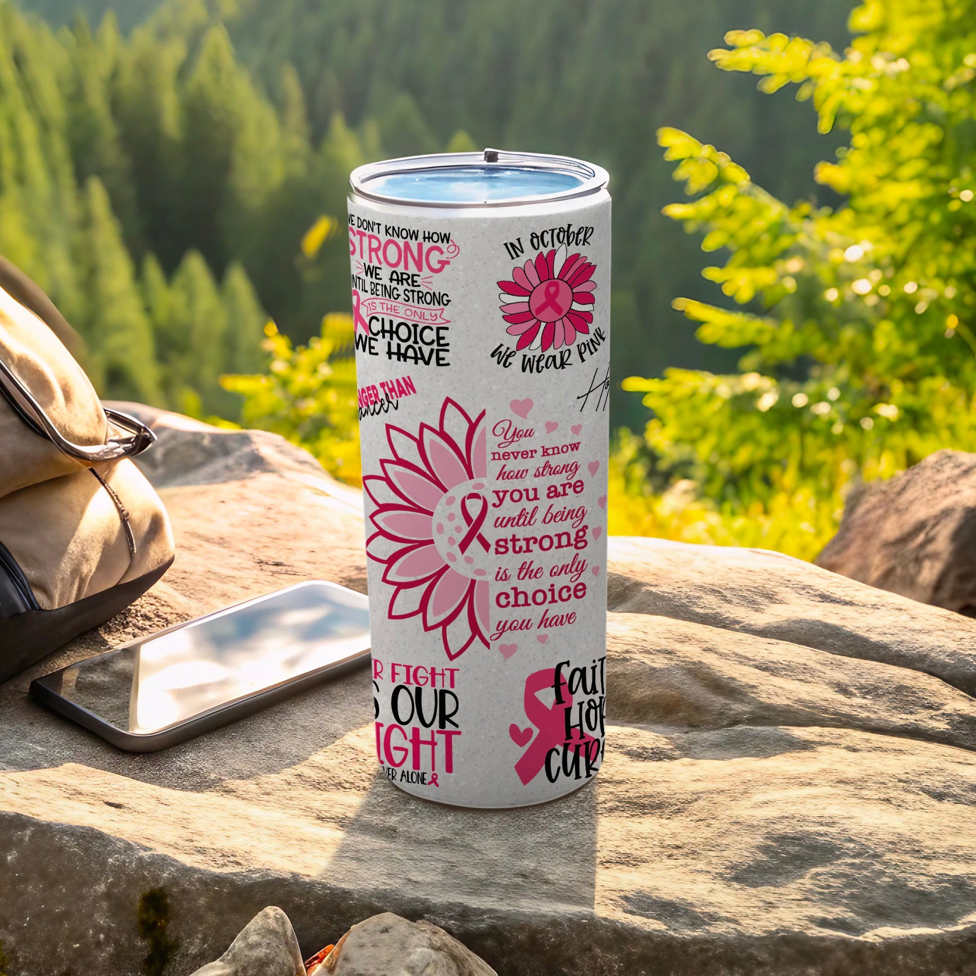 Pink ribbon tumbler with motivational text and floral accents.