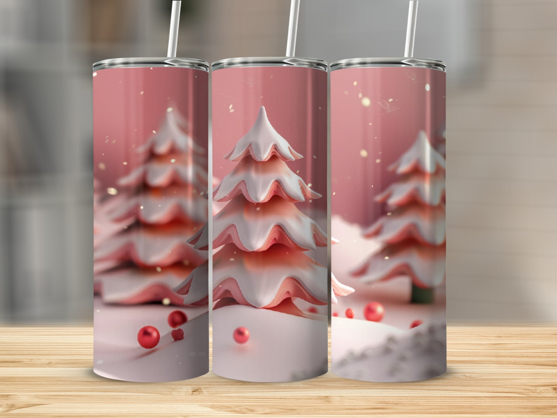 Three pink frosted Christmas trees with red ornaments on a pink background.