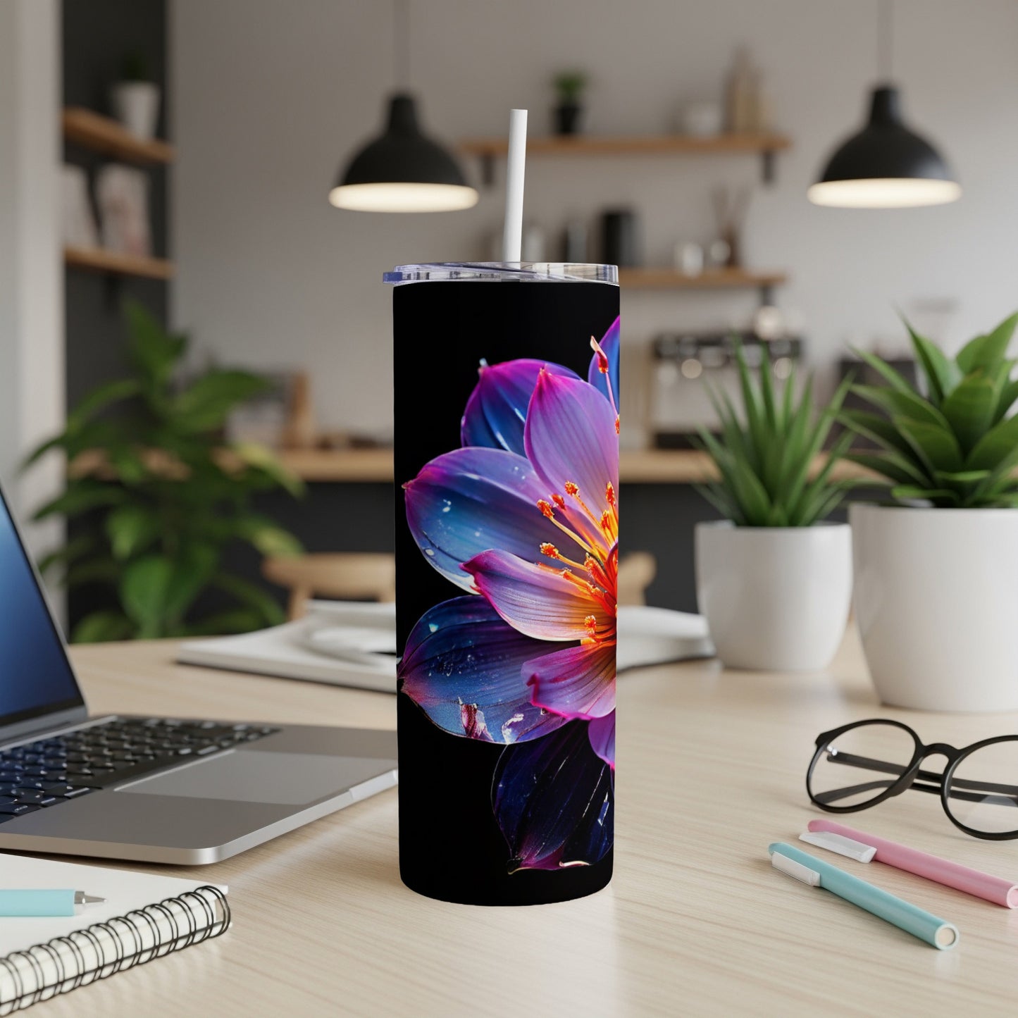 Tall tumbler with a vibrant pink and purple watercolor flower on a black background.