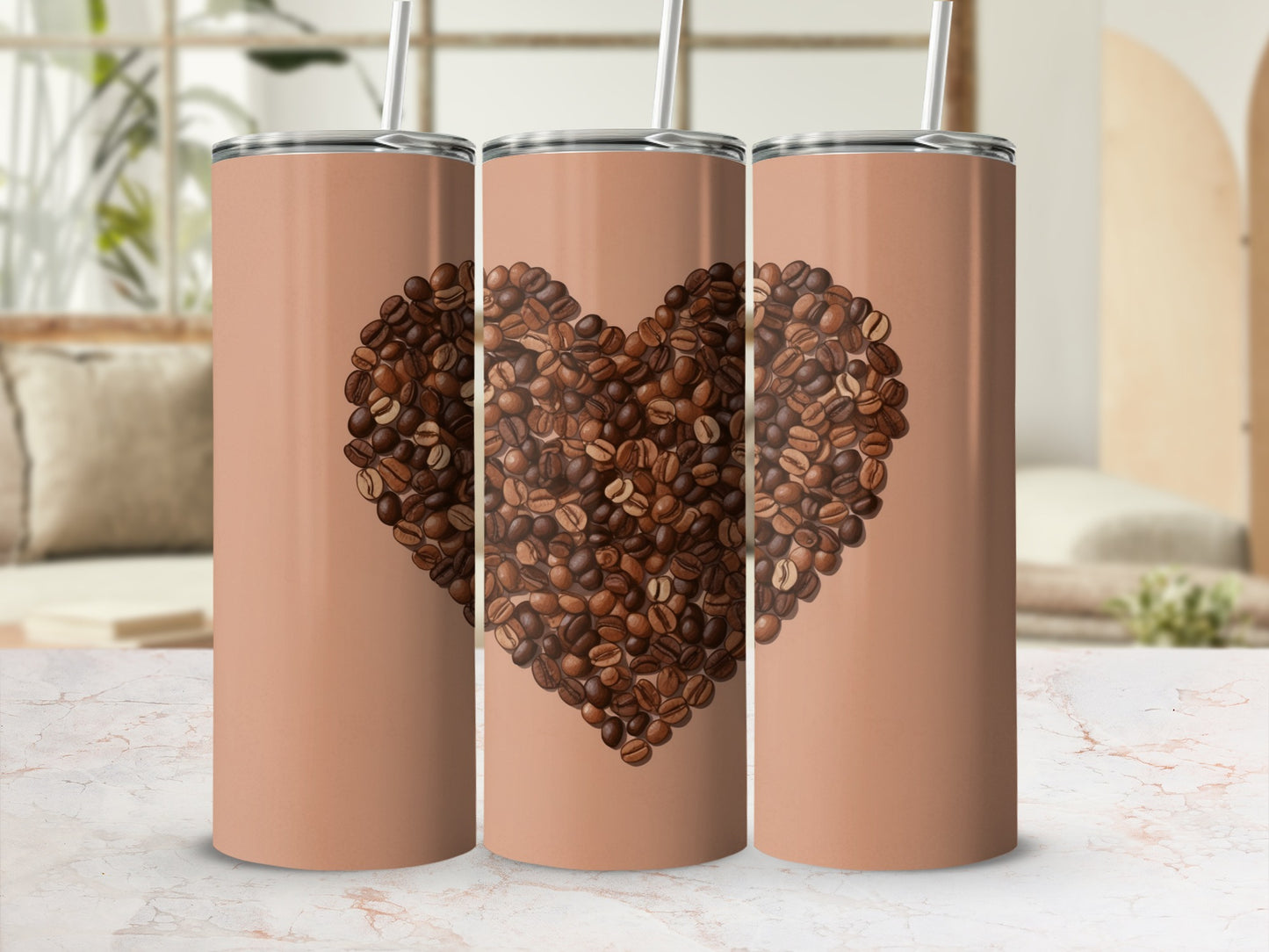 Three tan tumblers featuring a large coffee bean heart design.