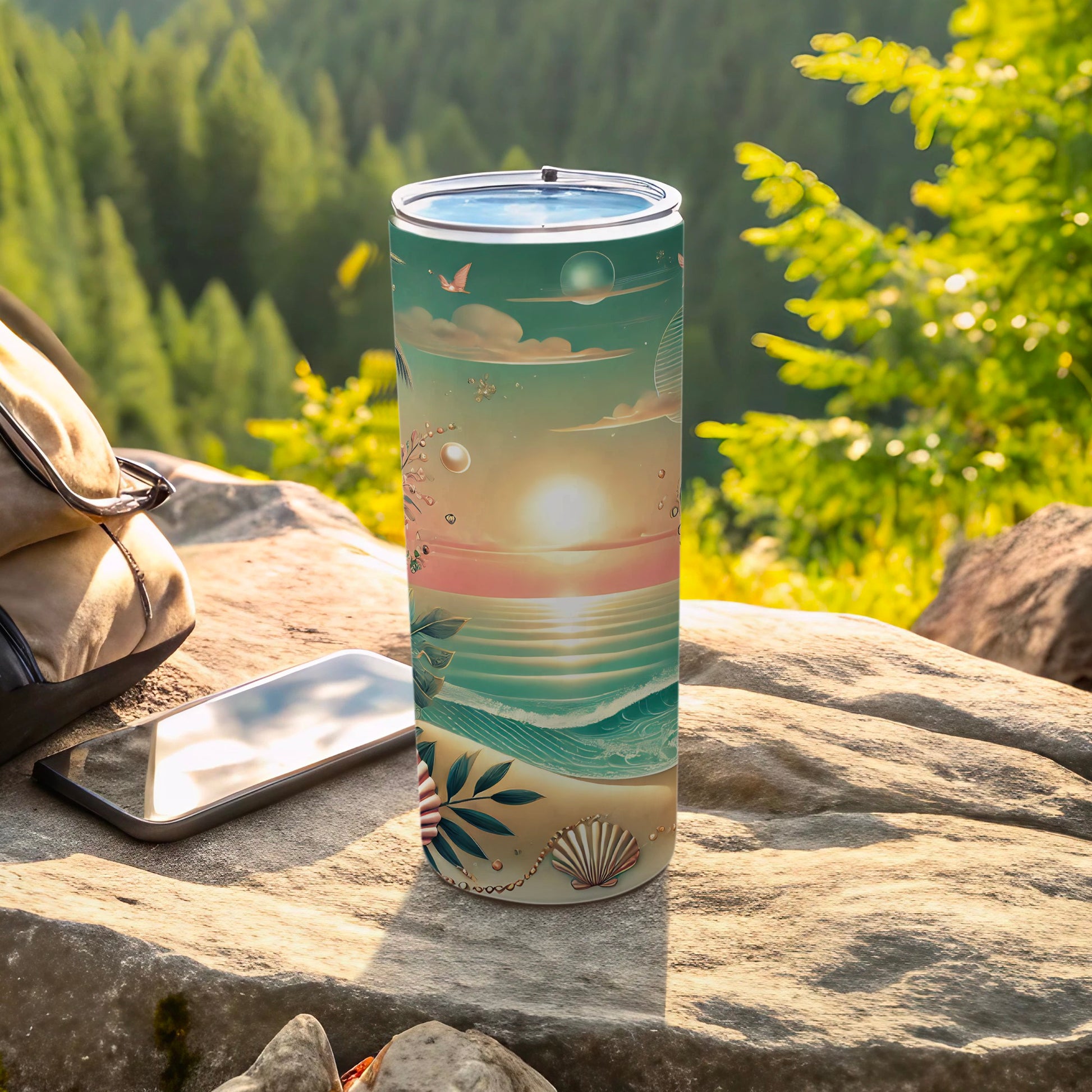 Tall tumbler with a beach sunset design on a rock.