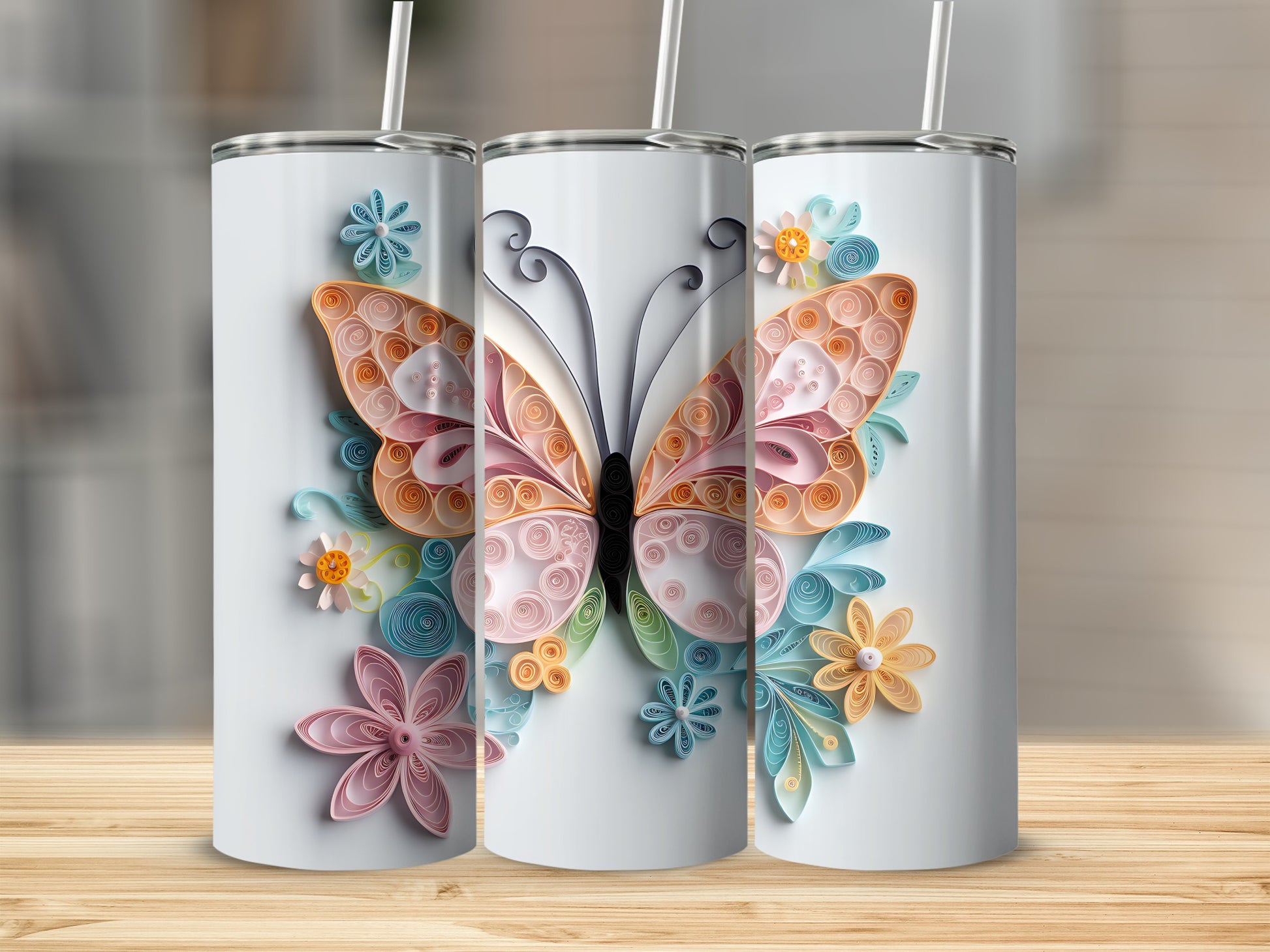 Three white tumblers decorated with quilled butterflies and flowers on a wooden surface.