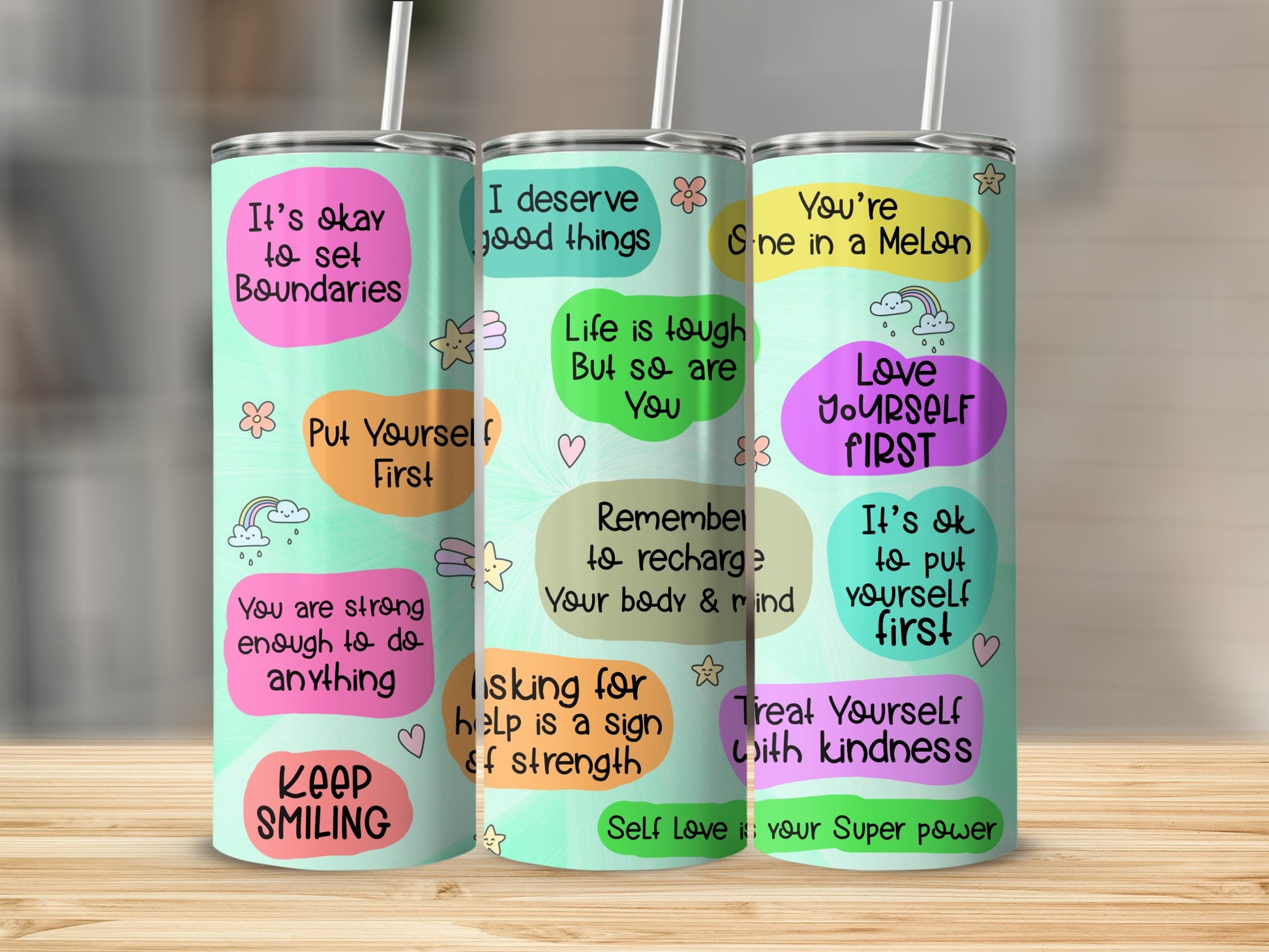 Three tumblers with empowering quotes in pastel colors.