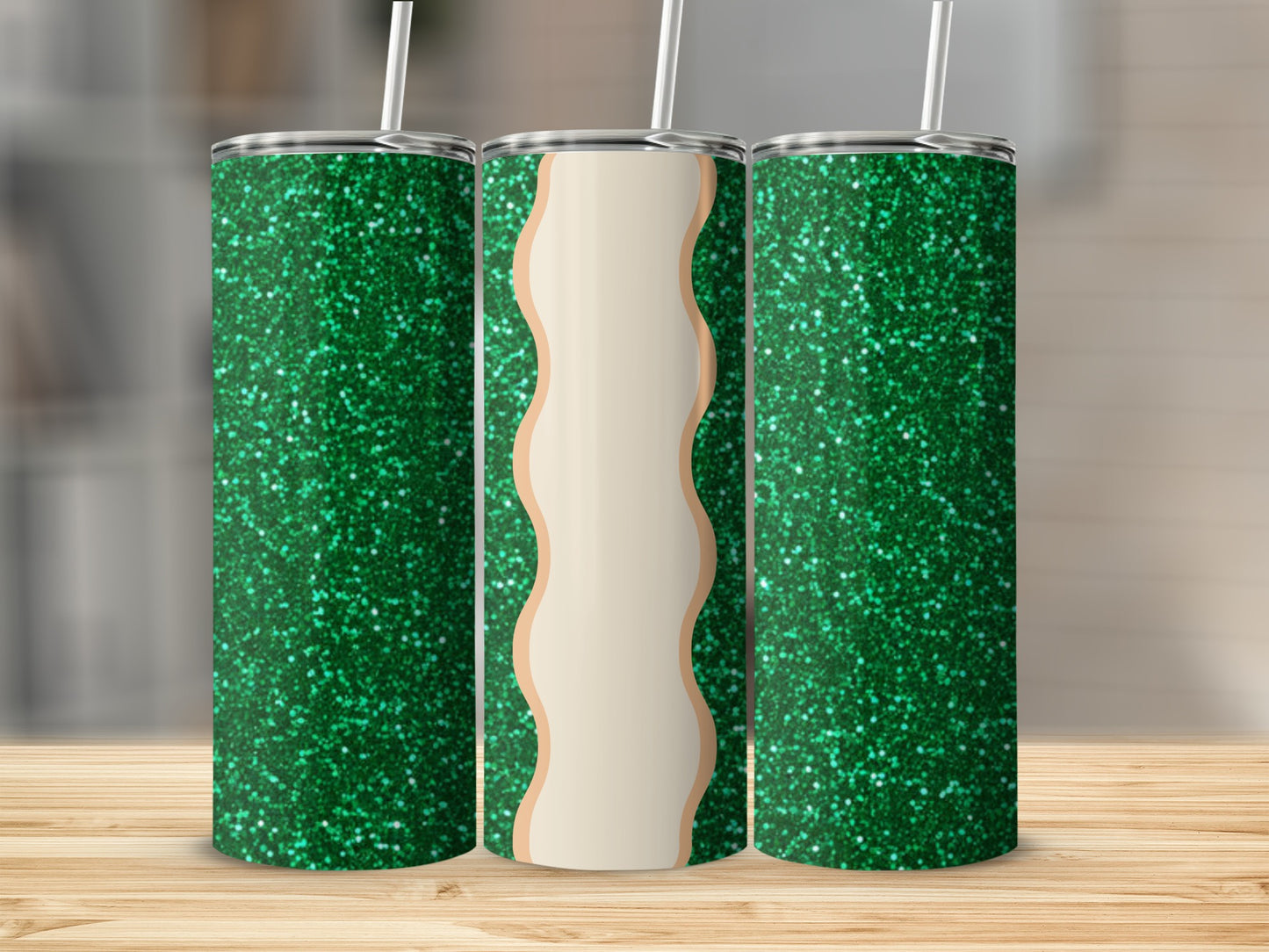Three glittery green tumblers with straws, one in the center featuring a light tan wave design.