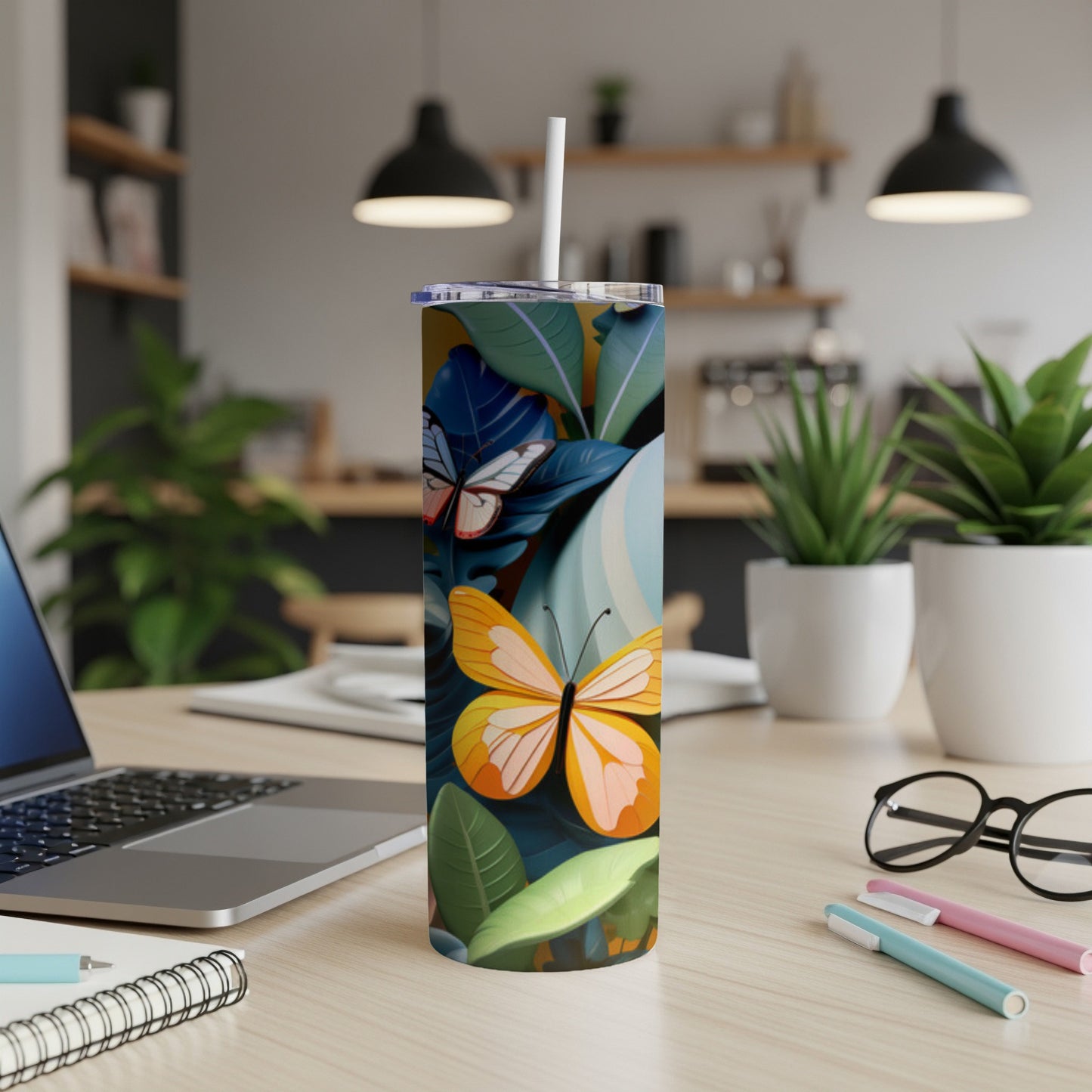 Tumbler with orange and blue butterflies and tropical leaves.